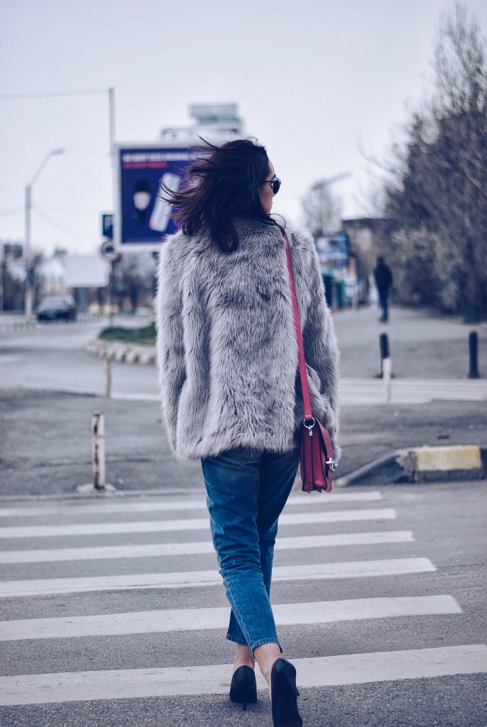 Faux fur, distressed boyfriend jeans, pumps, SoReal sunglasses by Andreea Birsan