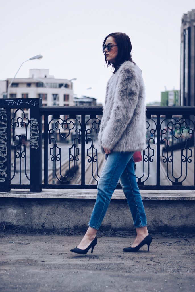 Faux fur, distressed boyfriend jeans, pumps, SoReal sunglasses by Andreea Birsan