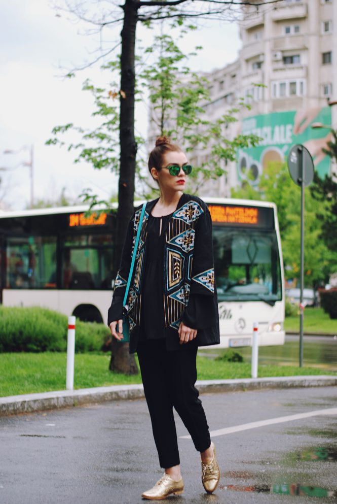 Embellished jacket, black bell sleeve blouse, black trousers, golden metallic shoes, green sunglasses, leather bag, spring outfit by Andreea Birsan