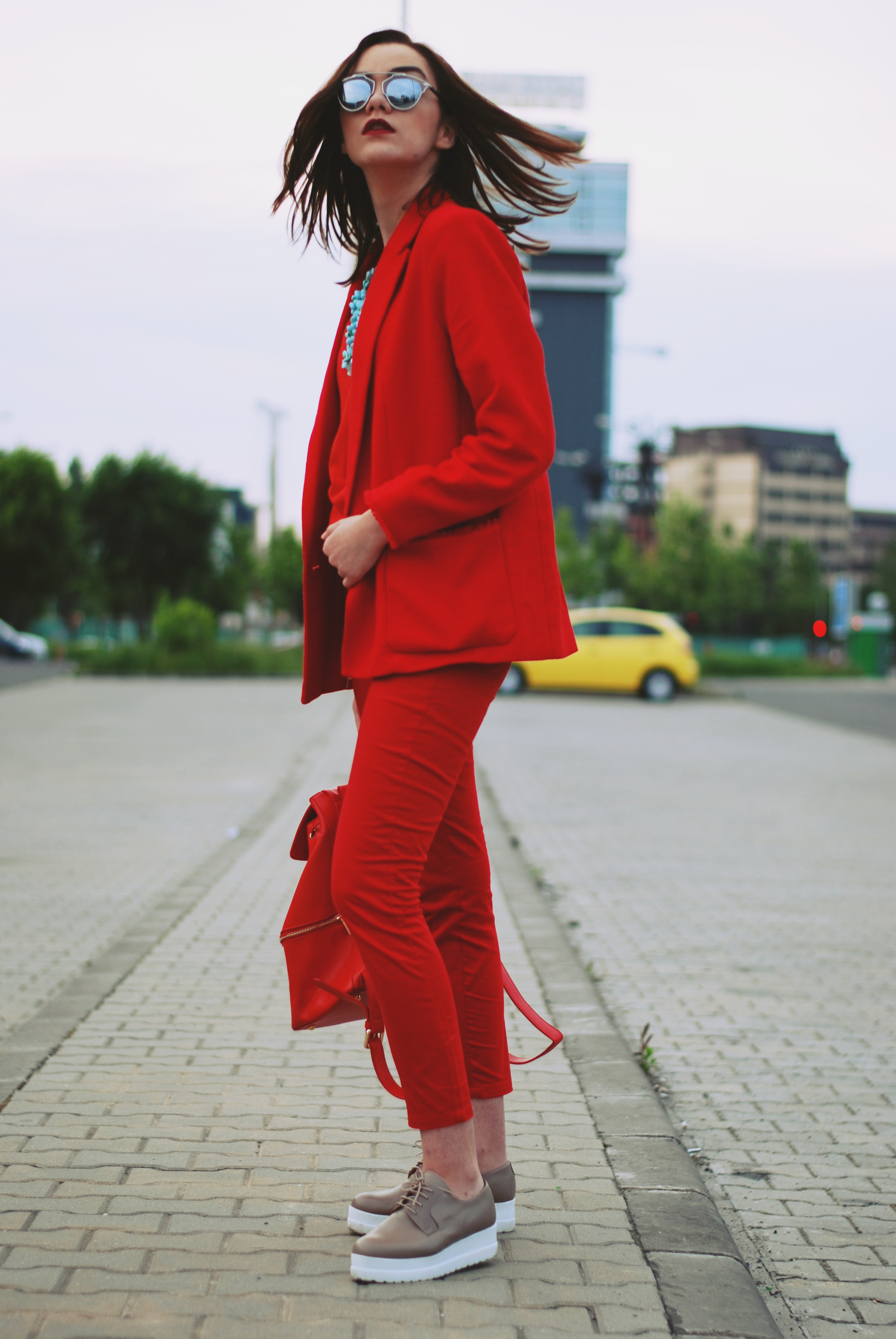 Red trousers, red blazer, red top, nude shoes, red backpack, all red outfit, statement necklace, spring outfit, so real sunglasses by Andreea Birsan