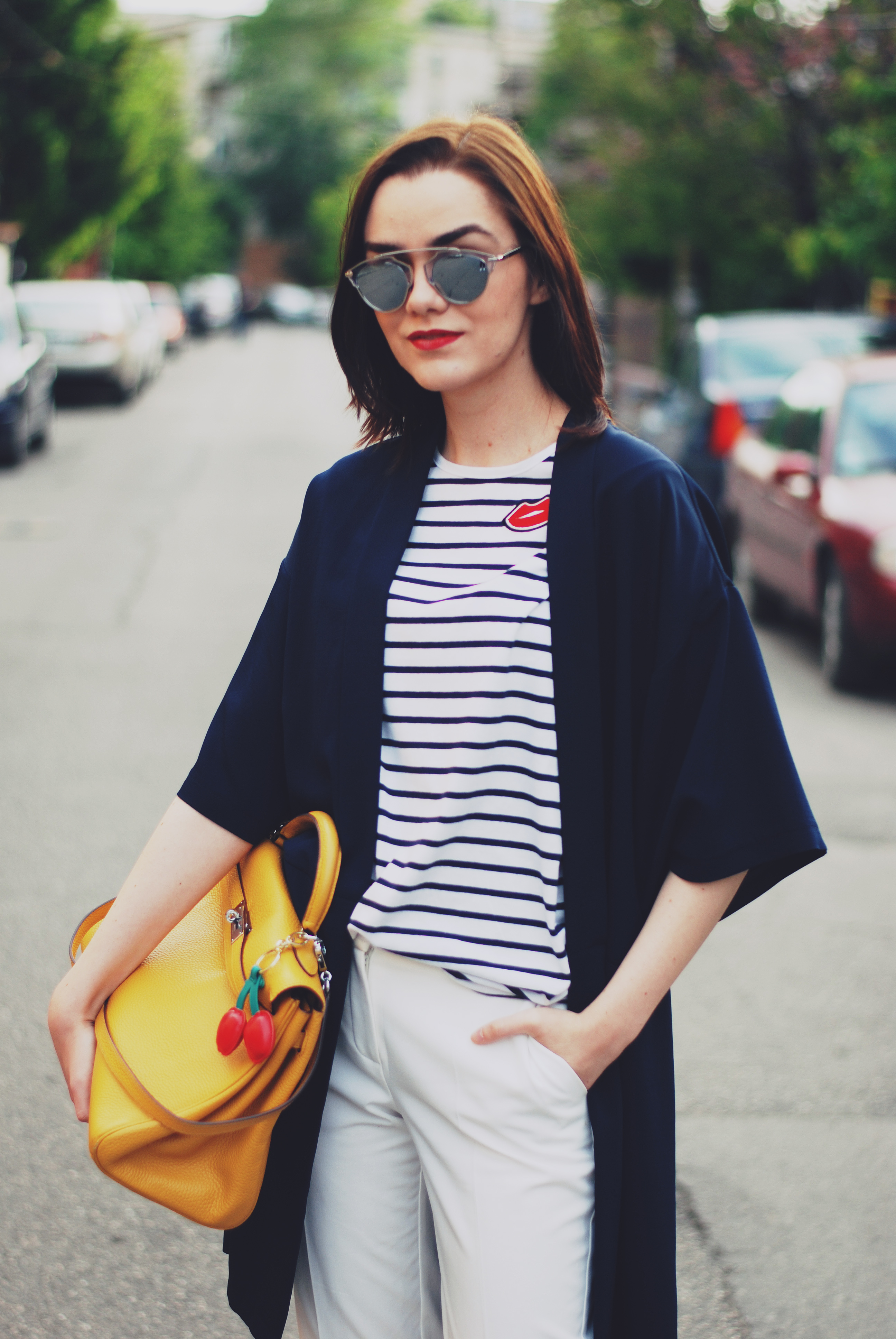 Striped tshirt, so real sunglasses, navy jacket, white trousers, yellow kelly bag, silver metallic shoes, spring outfit by Andreea Birsan