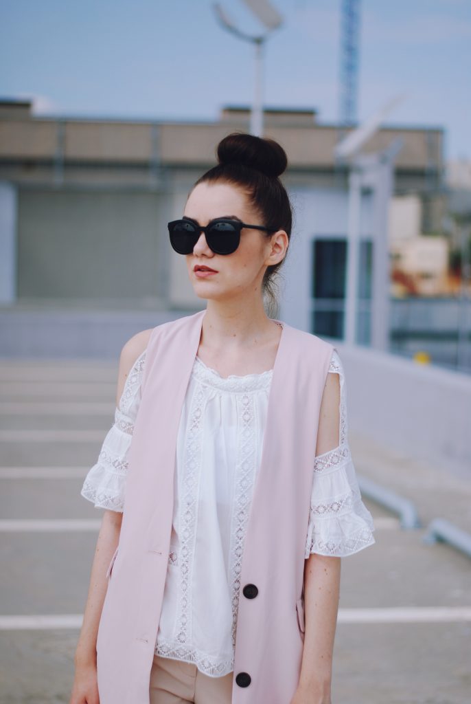 Pink trousers, lace cutout white blouse, black sunglasses, pink waistcoat vest, gold metallic oxford shoes, flower print bag, cute pink summer outfit, Andreea Birsan