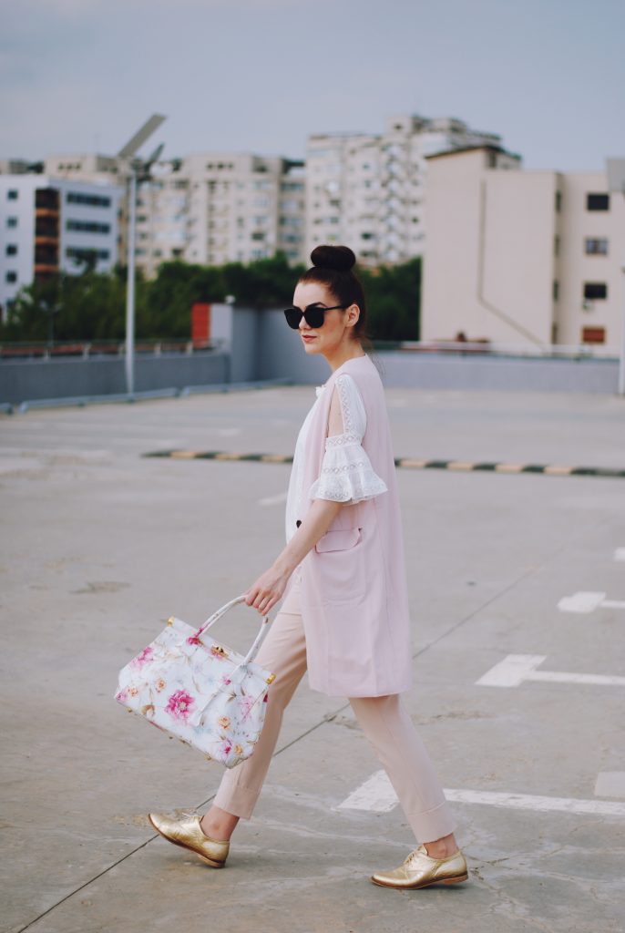 Pink trousers, lace cutout white blouse, black sunglasses, pink waistcoat vest, gold metallic oxford shoes, flower print bag, cute pink summer outfit, Andreea Birsan