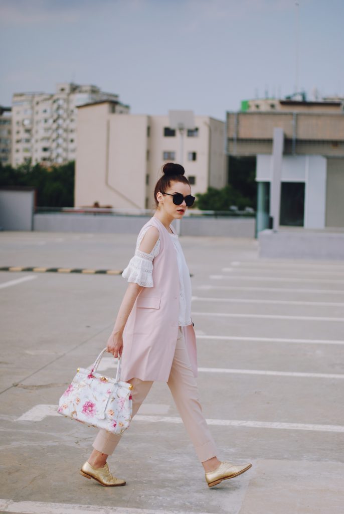 Pink trousers, lace cutout white blouse, black sunglasses, pink waistcoat vest, gold metallic oxford shoes, flower print bag, cute pink summer outfit, Andreea Birsan