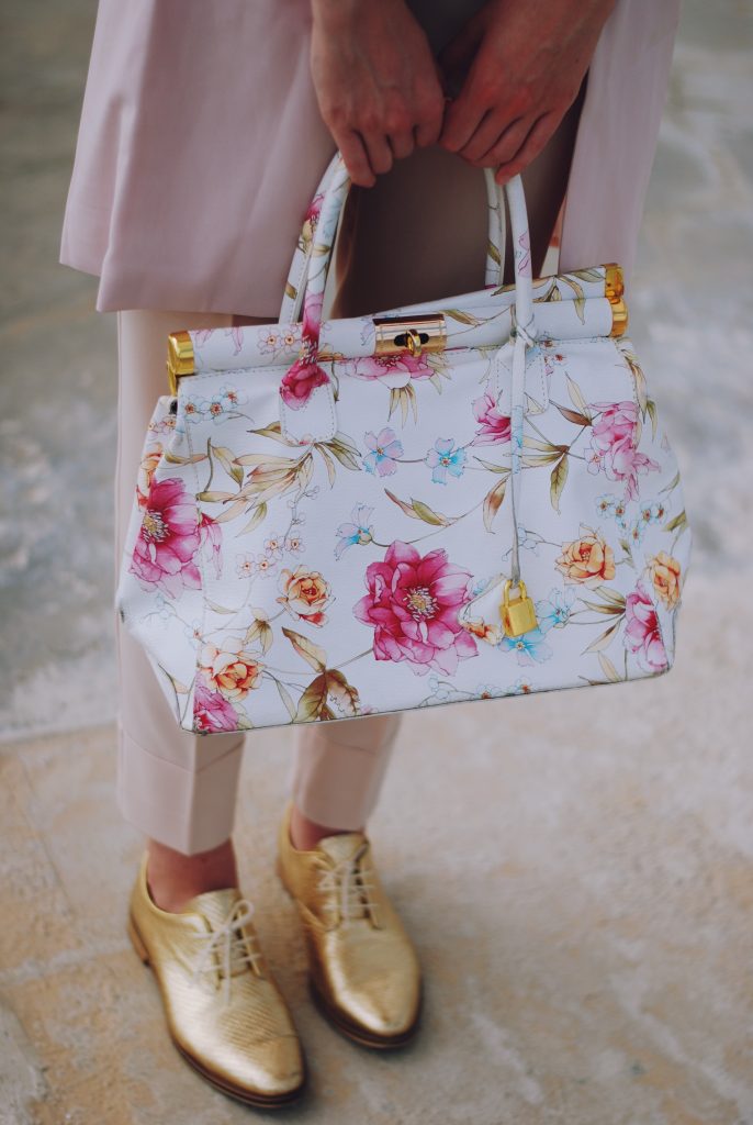 Pink trousers, lace cutout white blouse, black sunglasses, pink waistcoat vest, gold metallic oxford shoes, flower print bag, cute pink summer outfit, Andreea Birsan