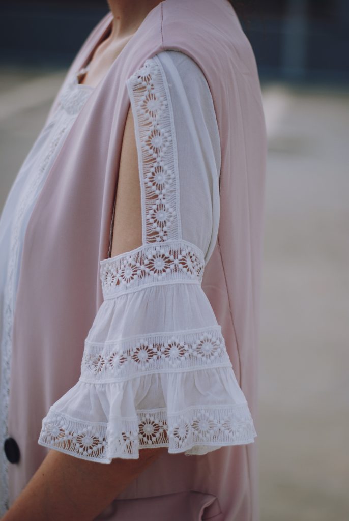 Pink trousers, lace cutout white blouse, black sunglasses, pink waistcoat vest, gold metallic oxford shoes, flower print bag, cute pink summer outfit, Andreea Birsan