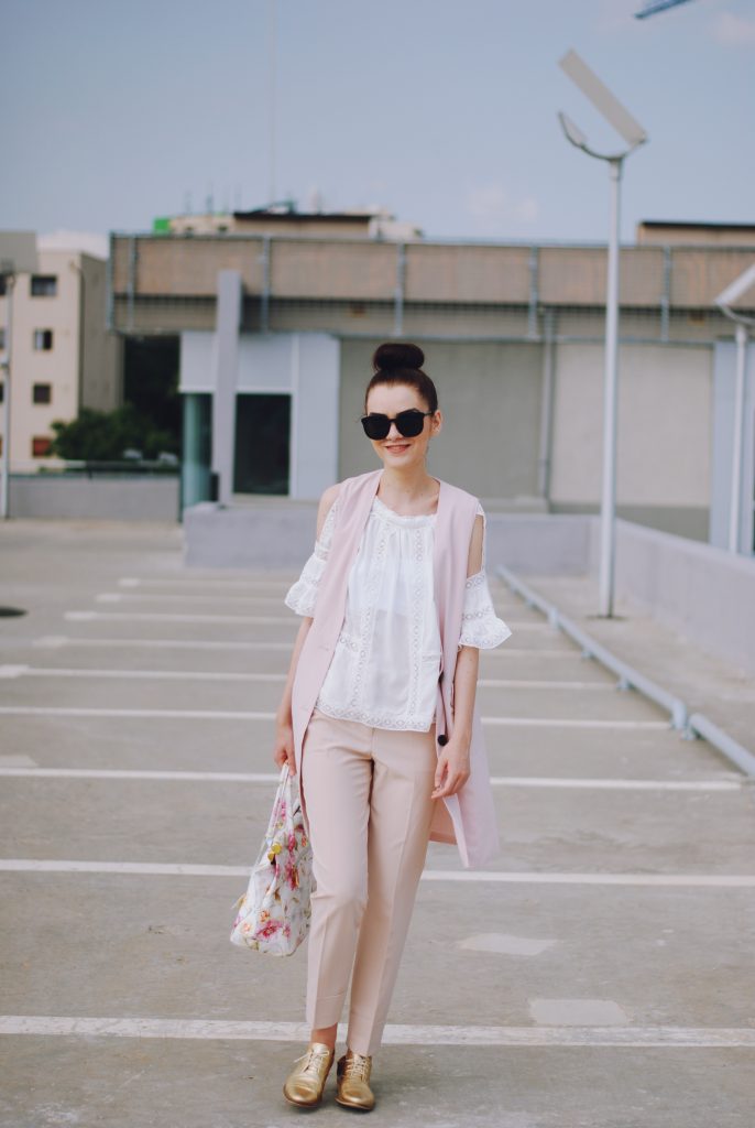 Pink trousers, lace cutout white blouse, black sunglasses, pink waistcoat vest, gold metallic oxford shoes, flower print bag, cute pink summer outfit, Andreea Birsan