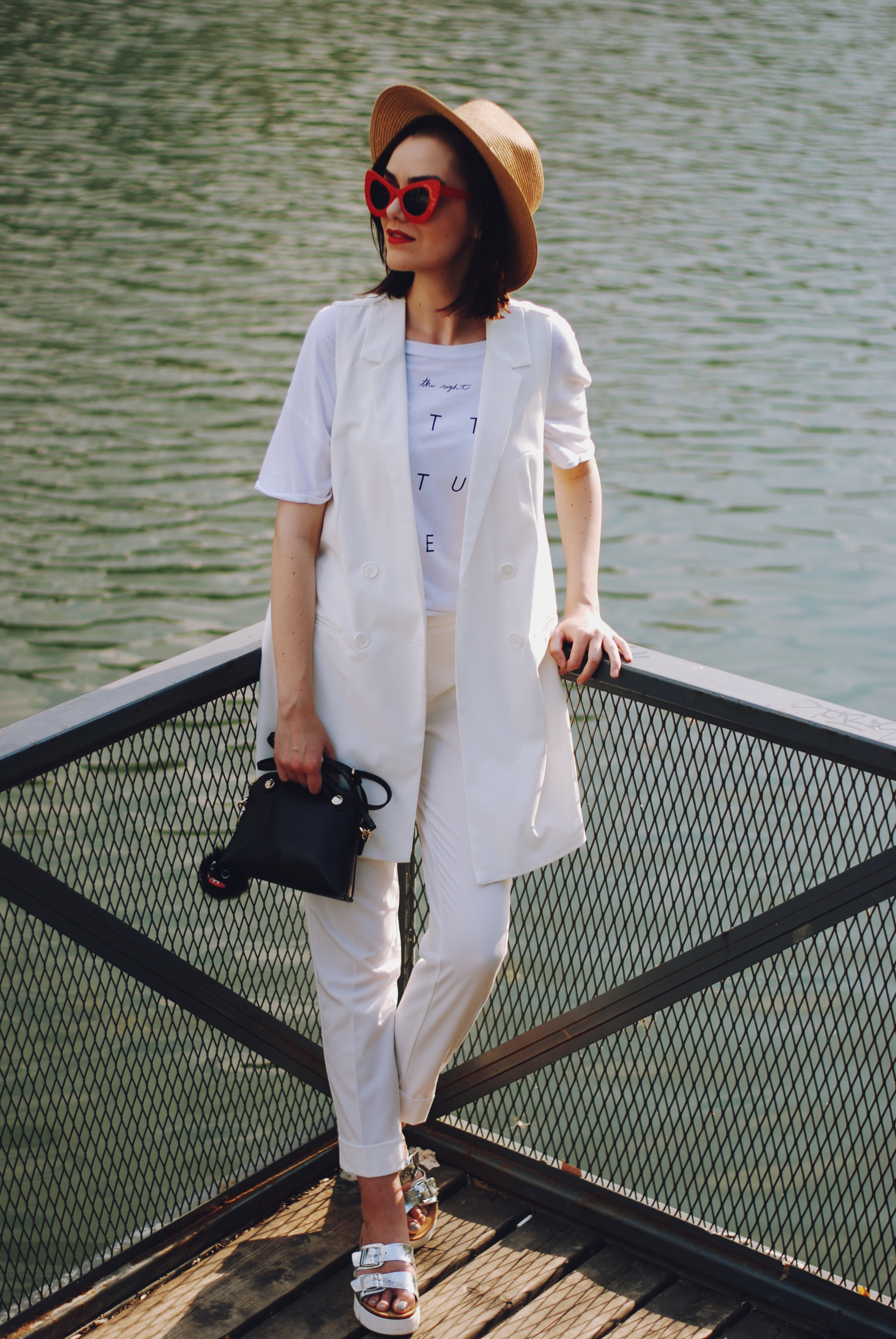 White summer outfit for the 4th of july, straw hat, red sunglasses, furla bag, white waistcoat vest, white tshirt, white trousers, silver metallic birkenstock sandals, Andreea Birsan