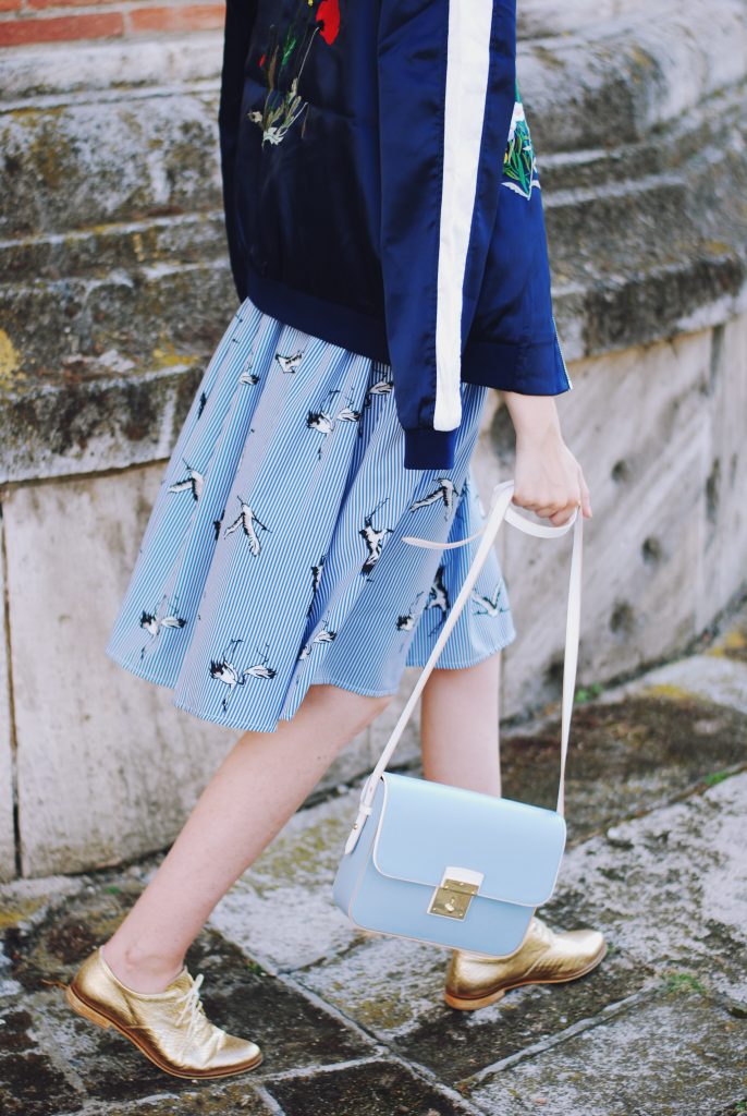 Embroidered bomber jacket, off shoulder top, baby blue crossbody bag, printed midi skirt, gold metallic shoes, sunglasses, fall outfit, Andreea Birsan