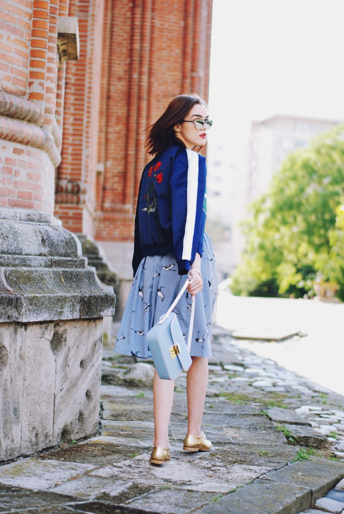 Embroidered bomber jacket, off shoulder top, baby blue crossbody bag, printed midi skirt, gold metallic shoes, sunglasses, fall outfit, Andreea Birsan