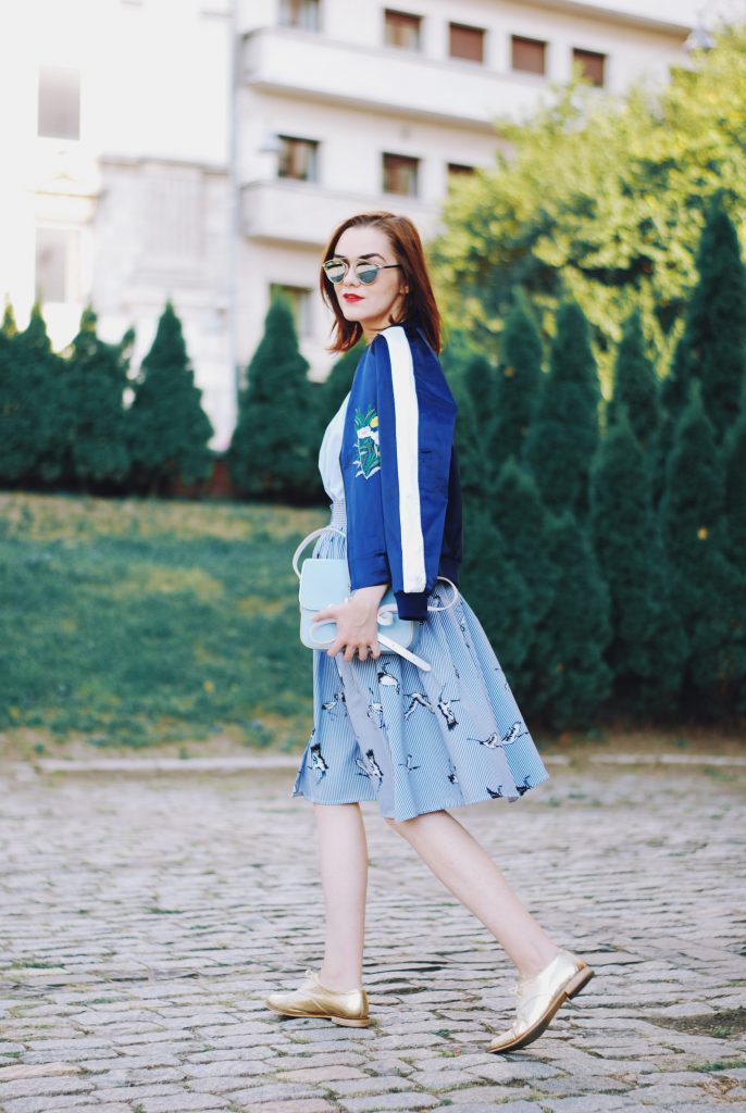 Embroidered bomber jacket, off shoulder top, baby blue crossbody bag, printed midi skirt, gold metallic shoes, sunglasses, fall outfit, Andreea Birsan