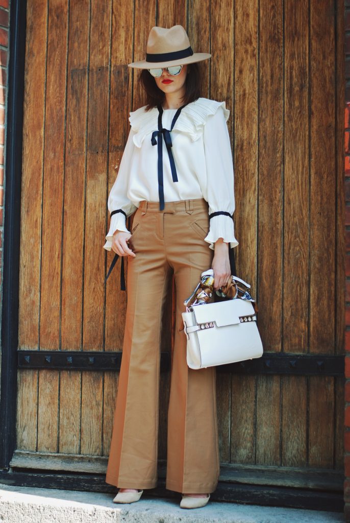 Camel fedora hat, camel flared pants trousers, ruffle top, scarf, white crossbody bag, beige pumps, dior sunglasses, cute autumn outfit idea, Andreea Birsan