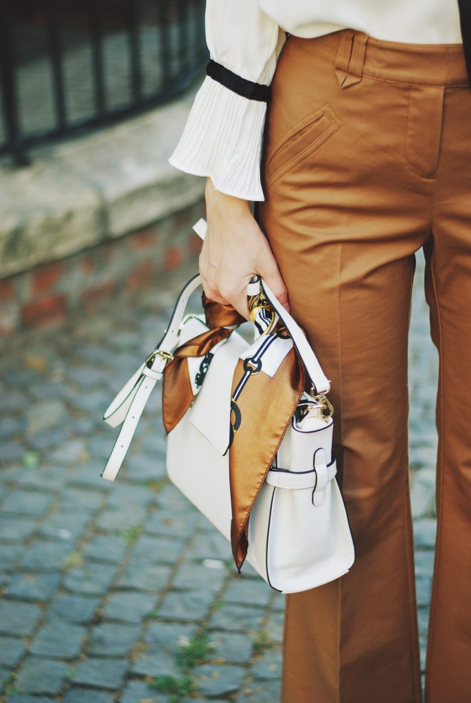 Camel fedora hat, camel flared pants trousers, ruffle top, scarf, white crossbody bag, beige pumps, dior sunglasses, cute autumn outfit idea, Andreea Birsan