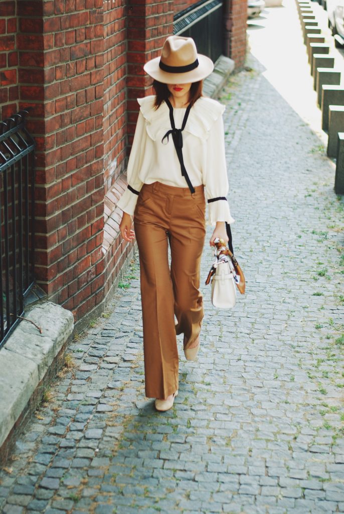 Camel fedora hat, camel flared pants trousers, ruffle top, scarf, white crossbody bag, beige pumps, dior sunglasses, cute autumn outfit idea, Andreea Birsan