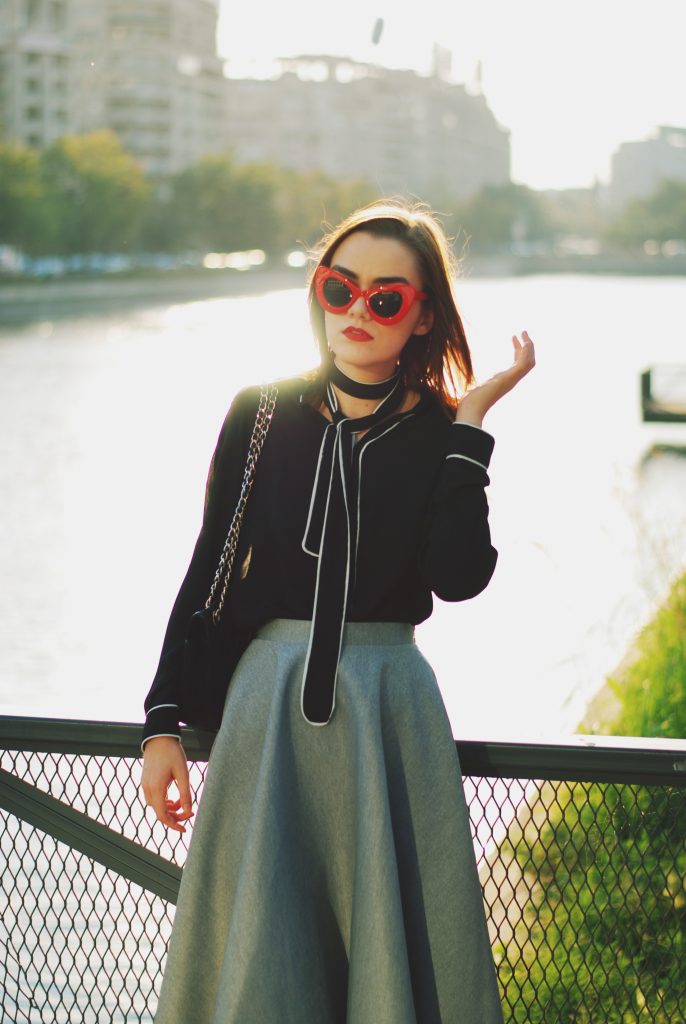 Waterfall midi grey skirt, scuba asymmetric grey skirt, contrast tie bow top, cat eye red sunglasses, black pointy toe pumps, black crossbody bag, quilted leather bag, chanel classic bag, chanel lookalike bag, cute fall outfit idea, Andreea Birsan, couturezilla, ootd, outfit of the day, romantic fall outfit inspiration, cute outfit for pinterest women, tumblr girls look, chic, chic on a budget, fashion trends for 2017, what to wear on a date night, black and grey, contrast top, tie bow neck blouse, how to look like a lady, european fashion blogger, romanian fashion blog, 2017 color combination, red cat eye sunglasses, fashion inspiration, how to wear a skirt