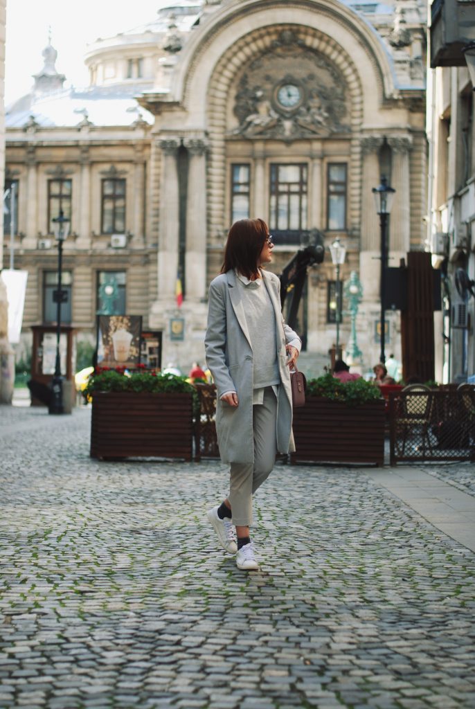 White shirt, grey pants trousers, grey sweater, grey coat, white sneakers, glitter socks, floral crossbody bag, all grey outfit for fall, Andreea Birsan