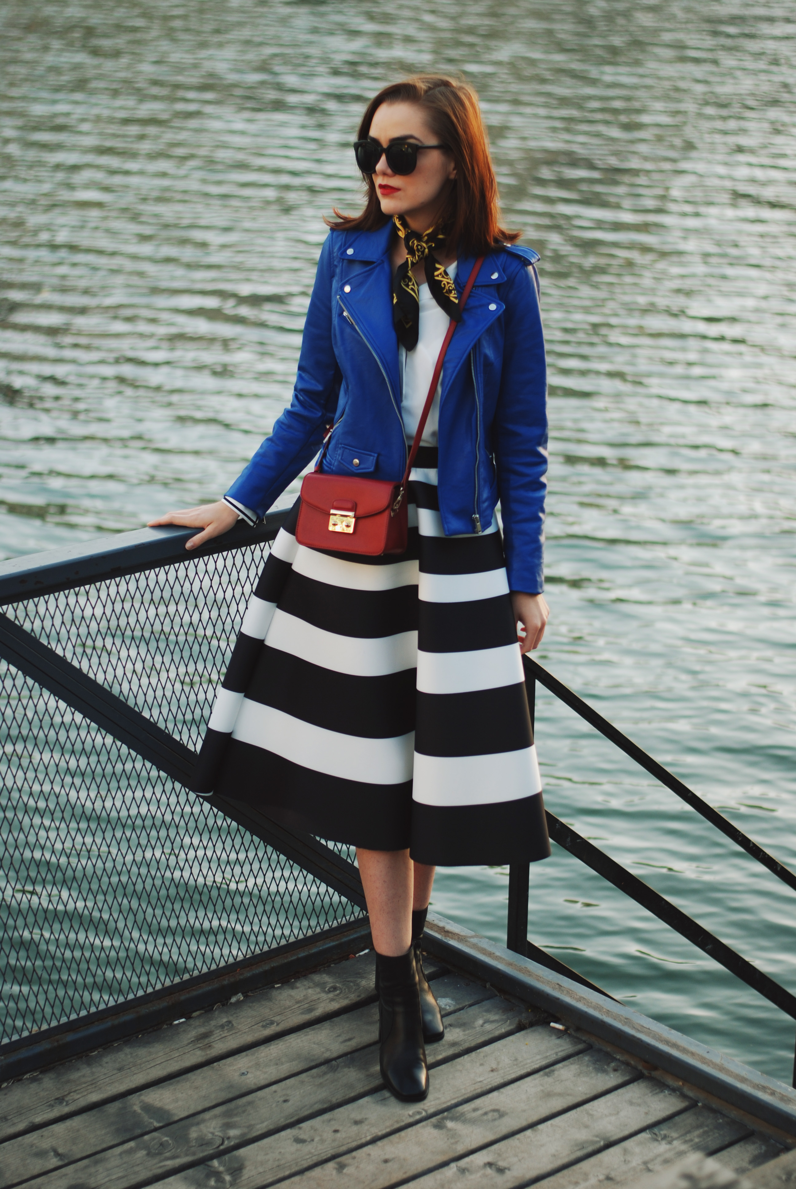 Blue leather jacket, white contrast top, cat eye sunglasses, striped midi skirt, zara leather ankle boots, red crossbody bag, scarf, cute best fall outfit idea, Andreea Birsan