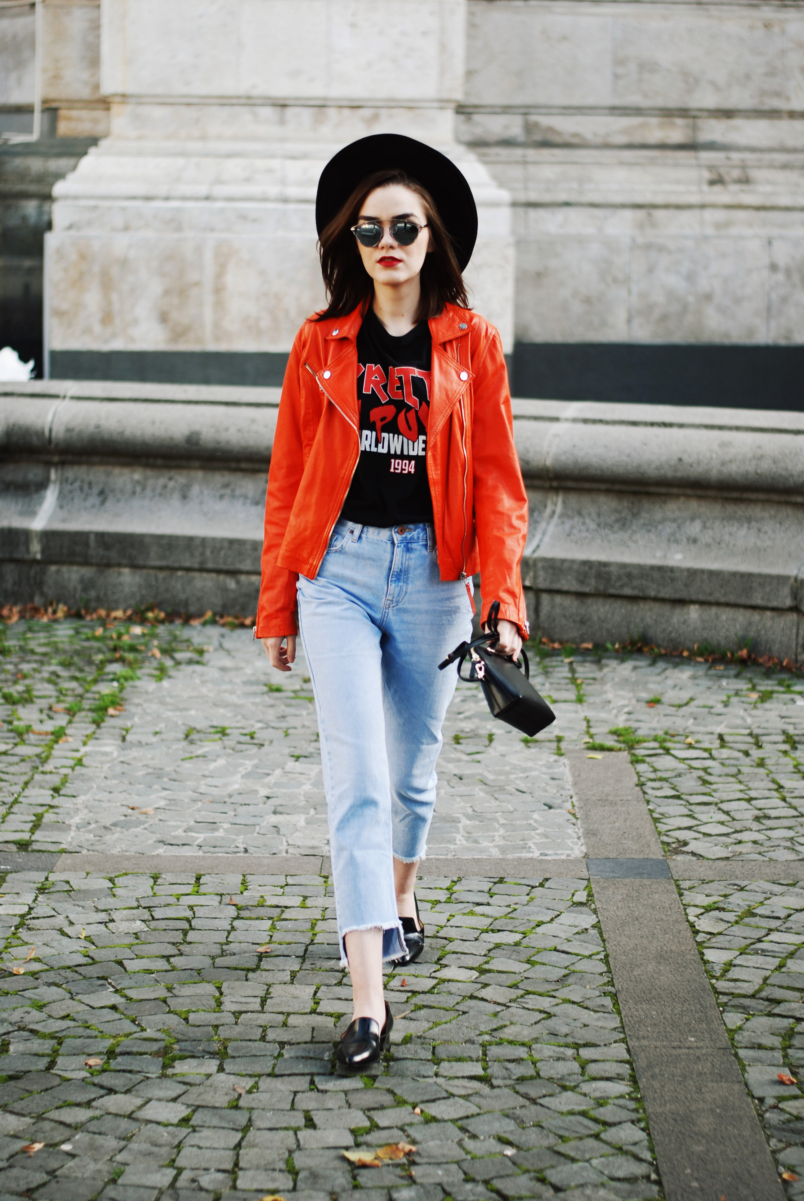 Orange leather jacket, step hemmed light wash mom jeans, zara punk graphic tshirt, black leather pointy toe loafers, furla piper s leather crossbody bag, black fedora hat, couturezilla, andreea birsan, christian dior mirrored sunglasses, cute and casual fall outfit ideas 2016