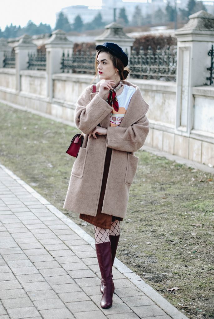 Brown suede midi wrap skirt, graphic tee, fishnet tights, zara navy military hat, tommy hilfiger knee high burgundy boots, furla metropolis red bag, H&M camel beige coat, silver hoop earrings andreea birsan, couturezilla, asos, mango, graphic tshirt, silky scarf, how to look parisian, topshop, fresh casual winter outfit ideas, what to wear a wrap skirt with, how to style knee high boots, pinterest outfits, tumblr outfit, ootd, european fashion blogger, romanian fashion blog