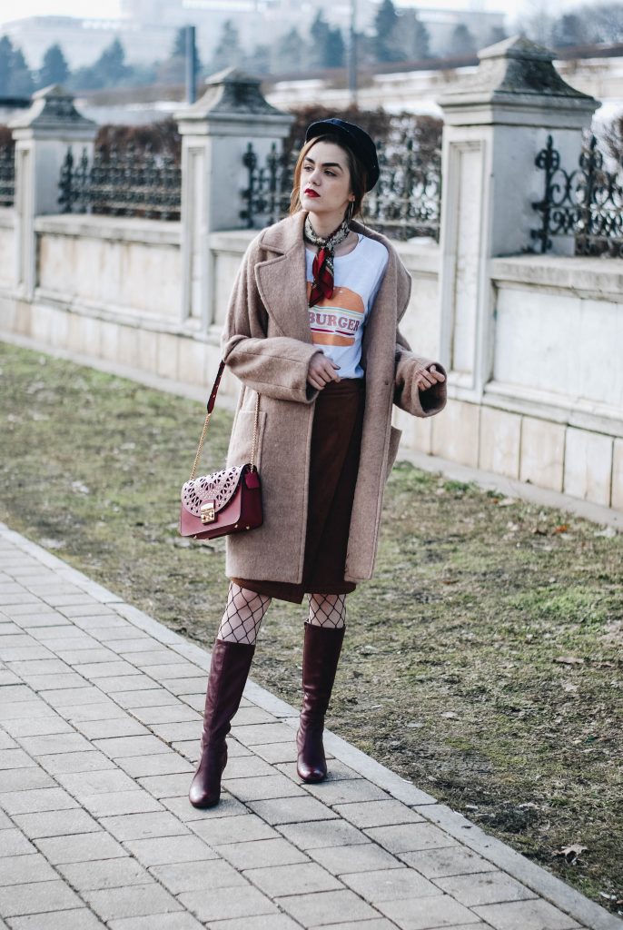 Brown suede midi wrap skirt, graphic tee, fishnet tights, zara navy military hat, tommy hilfiger knee high burgundy boots, furla metropolis red bag, H&M camel beige coat, silver hoop earrings andreea birsan, couturezilla, asos, mango, graphic tshirt, silky scarf, how to look parisian, topshop, fresh casual winter outfit ideas, what to wear a wrap skirt with, how to style knee high boots, pinterest outfits, tumblr outfit, ootd, european fashion blogger, romanian fashion blog