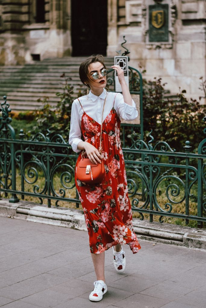 Mango midi red floral dress, asos white button down shirt, gucci ace heart white sneakers, topshop dress, white leather sneakers, kicks, red chloe drew bag, chloe drew lookalike bag, zara round 50mm mirrored sunglasses, ray ban sunnnies, gold earrings, layering with a slip dress, andreea birsan, couturezilla, cute spring outfit inspiration 2017, spring style, what to shop, chic oh a budget, spring minimal and girly outfit, european fashion blogger, romanian fashion blog, casual spring ootd, outfit of the day, minimal pinterest outfit for women, spring european street style 2017, tumblr girls inspo, red lipstick, messy bun, fashionista, leather crossbody bag, ruffle hem dress