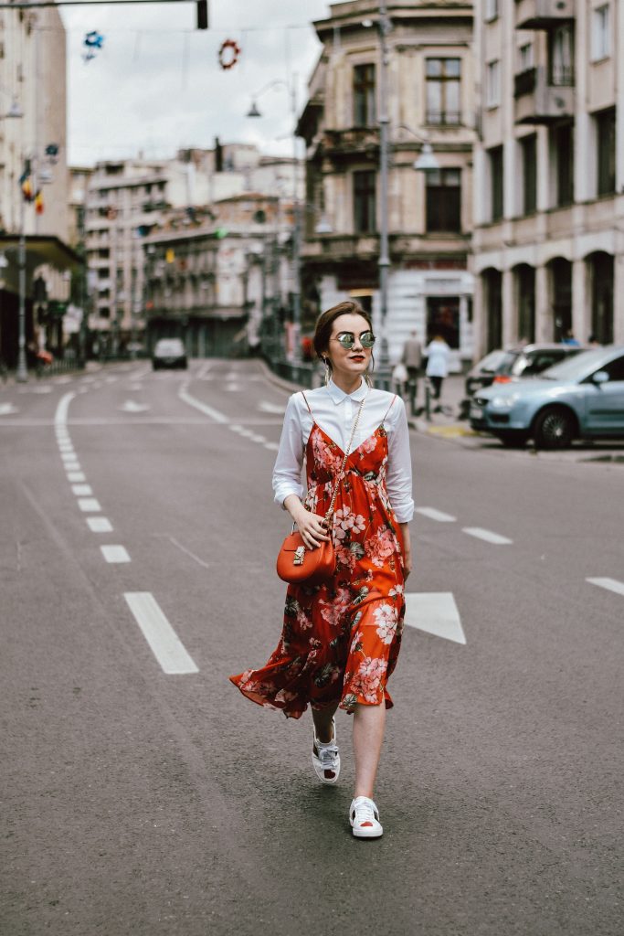 Mango midi red floral dress, asos white button down shirt, gucci ace heart white sneakers, topshop dress, white leather sneakers, kicks, red chloe drew bag, chloe drew lookalike bag, zara round 50mm mirrored sunglasses, ray ban sunnnies, gold earrings, layering with a slip dress, andreea birsan, couturezilla, cute spring outfit inspiration 2017, spring style, what to shop, chic oh a budget, spring minimal and girly outfit, european fashion blogger, romanian fashion blog, casual spring ootd, outfit of the day, minimal pinterest outfit for women, spring european street style 2017, tumblr girls inspo, red lipstick, messy bun, fashionista, leather crossbody bag, ruffle hem dress