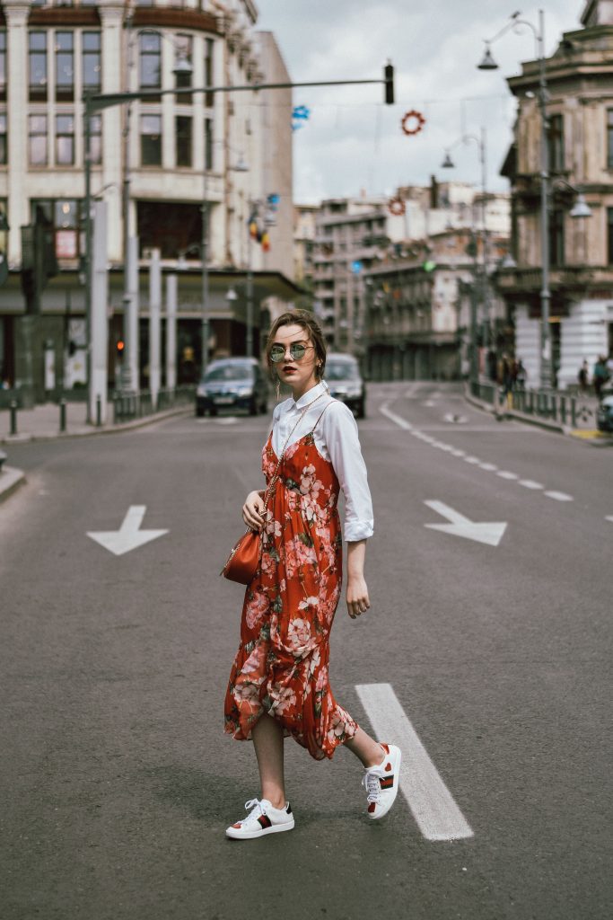 Mango midi red floral dress, asos white button down shirt, gucci ace heart white sneakers, topshop dress, white leather sneakers, kicks, red chloe drew bag, chloe drew lookalike bag, zara round 50mm mirrored sunglasses, ray ban sunnnies, gold earrings, layering with a slip dress, andreea birsan, couturezilla, cute spring outfit inspiration 2017, spring style, what to shop, chic oh a budget, spring minimal and girly outfit, european fashion blogger, romanian fashion blog, casual spring ootd, outfit of the day, minimal pinterest outfit for women, spring european street style 2017, tumblr girls inspo, red lipstick, messy bun, fashionista, leather crossbody bag, ruffle hem dress