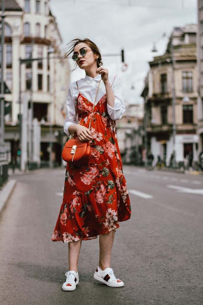 How to layer dresses for spring, red dress, zara tshirt, gucci sneakers, straw bag, micro sunglasses, andreea birsan, couturezilla, cute outfits 2018, midi trench inspired cotton dress, midi dress in red, white shirt and floral midi dress, how to layer dresses like a pro, best dresses for spring 2018, floral print dress, striped t-shirt, tee, organic cotton tshirt, zara tshirts, asos micro sunglasses, red cat eye sunglasses, white oval sunglasses, peonies, straw bags, pom pom bags, straw bag, raffia bag, basket bag trend, red pom pom bag, gucci sneakers in white, white and red gucci sneakers, how to wear a dress with sneakers, gucci ace heart embroidered sneakers, pearl embellished red sandals, dress over skirt, midi striped skirt, green gucci dionysus inspired bag, green shoulder bag, chloe drew bag in red, red chloe drew bag, red suede slingback kitten heels, the best way to layer dresses, how to layer dresses this spring, statement earrings, straw hat, straw hat and dresses for spring and summer, cute outfit ideas 2018, how to look Parisian chic, European summer street style inspiration for women 2017, pinterest chic outfit ideas for woman, summer outfit ideas, summer ootd inspiration, outfit of the day, ootd, fashion icon, style inspiration, fashionista, fashion inspiration, style inspo, what to wear in summer, how to look French, chic on a budget, zara outfit, mango, topshop, asos, river island, forever 21, urban outfitters, how to mix high end pieces with luxury ones, zara and Gucci,outfit alternatives for summer, tomboy chic, minimal outfit, tumblr girls photos, pictures, happy girl, women, smart casual outfits, the best outfit ideas 2017, what to wear when you don’t feel inspired, summer in Europe, weekend attire, uniform, French women in summer, European outfit ideas 2017, minimal chic outfit, how to stand out, the best outfit ideas for summer, the sunglasses you have seen everywhere on Instagram, glasses, uk fashion blogger, united kingdom, uk fashion blog, fashion and travel blog, Europe, women with style, street style, summer fashion trends 2017, best fashion ideas, styling, fall fashion, fall outfit, fall ootd, fall perfect, transitional dressing, best transitional outfit ideas, how to wear statement earrings, dressing for autumn, autumn outfit, winter outfit ideas for work and school 2017