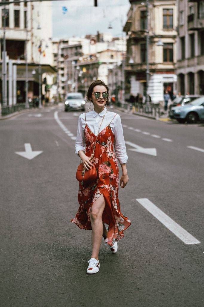 Mango midi red floral dress, asos white button down shirt, gucci ace heart white sneakers, topshop dress, white leather sneakers, kicks, red chloe drew bag, chloe drew lookalike bag, zara round 50mm mirrored sunglasses, ray ban sunnnies, gold earrings, layering with a slip dress, andreea birsan, couturezilla, cute spring outfit inspiration 2017, spring style, what to shop, chic oh a budget, spring minimal and girly outfit, european fashion blogger, romanian fashion blog, casual spring ootd, outfit of the day, minimal pinterest outfit for women, spring european street style 2017, tumblr girls inspo, red lipstick, messy bun, fashionista, leather crossbody bag, ruffle hem dress