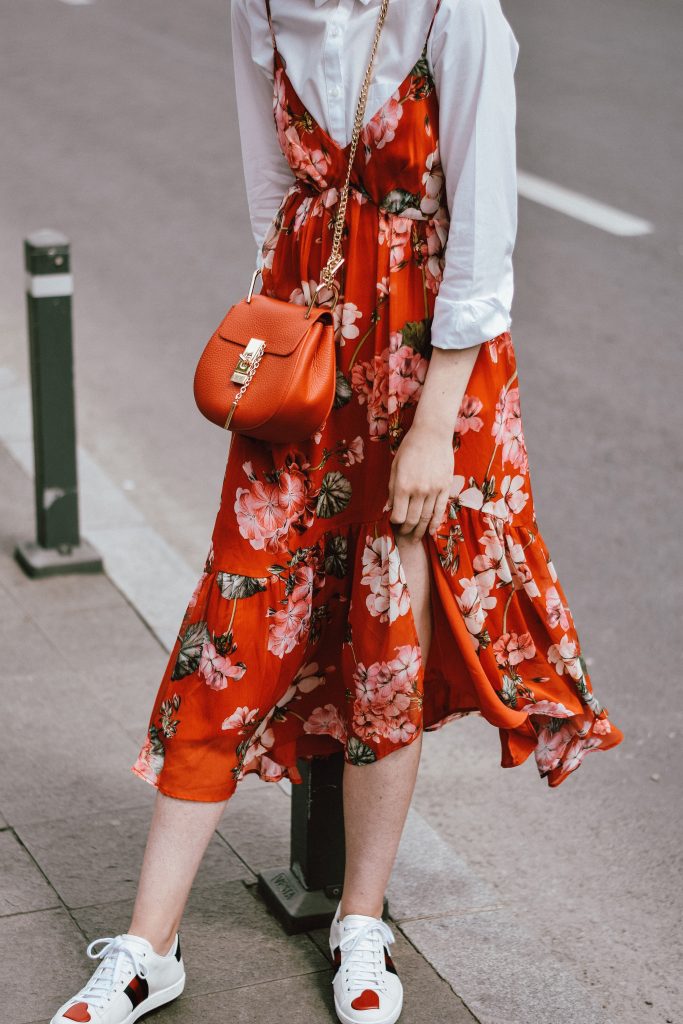 Mango midi red floral dress, asos white button down shirt, gucci ace heart white sneakers, topshop dress, white leather sneakers, kicks, red chloe drew bag, chloe drew lookalike bag, zara round 50mm mirrored sunglasses, ray ban sunnnies, gold earrings, layering with a slip dress, andreea birsan, couturezilla, cute spring outfit inspiration 2017, spring style, what to shop, chic oh a budget, spring minimal and girly outfit, european fashion blogger, romanian fashion blog, casual spring ootd, outfit of the day, minimal pinterest outfit for women, spring european street style 2017, tumblr girls inspo, red lipstick, messy bun, fashionista, leather crossbody bag, ruffle hem dress