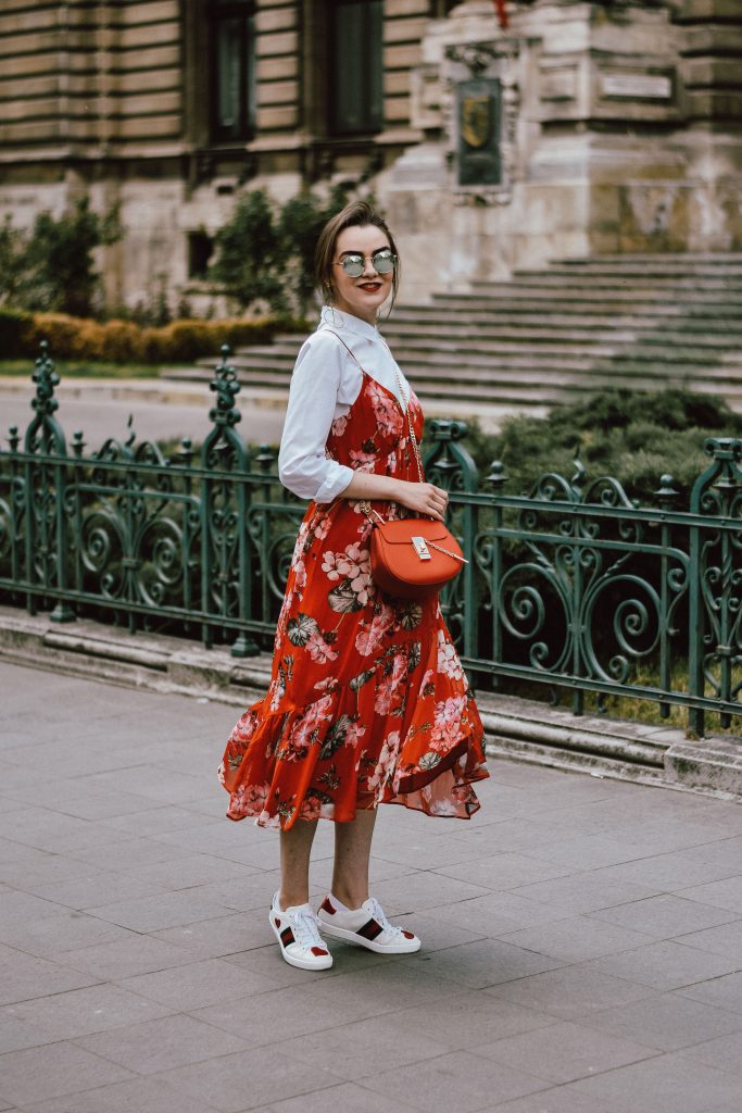 Mango midi red floral dress, asos white button down shirt, gucci ace heart white sneakers, topshop dress, white leather sneakers, kicks, red chloe drew bag, chloe drew lookalike bag, zara round 50mm mirrored sunglasses, ray ban sunnnies, gold earrings, layering with a slip dress, andreea birsan, couturezilla, cute spring outfit inspiration 2017, spring style, what to shop, chic oh a budget, spring minimal and girly outfit, european fashion blogger, romanian fashion blog, casual spring ootd, outfit of the day, minimal pinterest outfit for women, spring european street style 2017, tumblr girls inspo, red lipstick, messy bun, fashionista, leather crossbody bag, ruffle hem dress