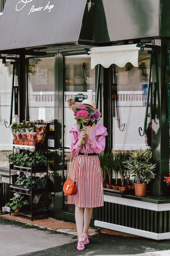 H&M pink ruffle shirt, dramatic top trend, frills, topshop ruffle blouse, asos pretty summer top, red cat eye sunglasses, retro sunnies, zara red and white striped midi skirt, colorblock stripe midi skirt, stripes, nautical, gucci mules, gucci lookalike slides, gucci princetown mules, pink shoes, pink embroidered mules, mango pink mules, gucci double buckle black leather belt, boater straw hat, straw fedora hat, raffia, summer trends 2017, girls and flowers, flower shop, red chloe drew crossbody bag, red leather bag, chloe drew lookalike bag, chic on a budget, under 100$ outfit, andreea birsan, couturezilla, cute spring outfit ideas, european spring street style inspiration, how to look parisian chic, minimal, french knotted plum scarf, violet silk scarf, silver hoop earrings, how to dress for spring in a smart casual way, work attire, chic outfit for women, casual pinterest outfit for women, happy tumblr girls, fashionista, european fashion blogger, romanian fashion blog, how to wear a midi skirt, how to wear red and pink together, color mixing, what to wear on a weekend, fashion blogger, 2017 fashion trends, ootd, outfit of the day, sweet outfit, darling look