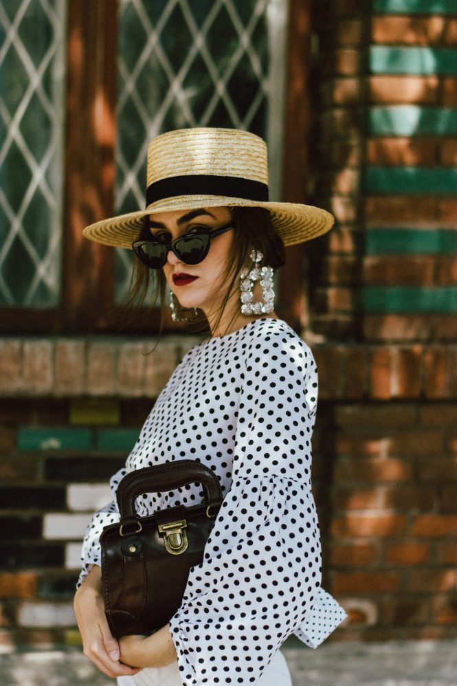 Polka dot balloon sleeve top, zara white high waisted shorts, beara beara vintage inspired bag, straw boater hat, statement earrings, vintage bag, white leather statement pumps, andreea birsan, couturezilla, cute summer outfit ideas 2017, puffy sleeves polka dot blouse, tie back top, dramatic top, black retro cat eye sunglasses, sequin earrings, exaggerated earrings, mini vintage looking dark red leather bag, burgundy, the adult way to wear shorts, perfect shorts length, retro inspired outfit, how to look Parisian chic, European summer street style inspiration for women 2017, pinterest chic outfit ideas for woman, summer outfit ideas, summer ootd inspiration, outfit of the day, ootd, fashion icon, style inspiration, fashionista, fashion inspiration, style inspo, what to wear in summer, how to look French, chic on a budget, zara outfit, mango, topshop, asos, river island, forever 21, urban outfitters, how to mix high end pieces with luxury ones, zara and Gucci, how to look chic when not wearing a dress, outfit alternatives for summer, tomboy chic, minimal outfit, tumblr girls photos, pictures, happy girl, women, smart casual outfits, the best outfit ideas 2017, what to wear when you don’t feel inspired, summer in Europe, weekend attire, uniform, French women in summer, European outfit ideas 2017, minimal chic outfit, how to stand out, the best outfit ideas for summer, the sunglasses you have seen everywhere on Instagram, glasses, uk fashion blogger, united kingdom, uk fashion blog, fashion and travel blog, Europe, women with style, street style, summer fashion trends 2017, best fashion ideas, styling