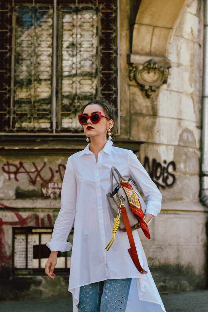 Zara white waterfall asymmetric shirt, white button down shirt, asymmetric shirt asos, where to find the best shirt dress, mango eyelet mom jeans, levi’s light wash mom jeans, 501 ct, jeans with eyelets, eyelet detail denim, statement denim, statement jeans, longline white button down shirt stradivarius, public desire pearl red sandals, srappy pearl embellished red sandals, coral red shoes, block heel sandals, best heel size for summer, statement shoes,, radley grey tote bag, leather medium everyday bag, work-life bag, best everyday bag for women, red cat eye sunglasses, cat eye sunglasses for women, statement sunglasses, retro inspired sunglasses, andreea birsan, couturezilla, cute summer outfit inspiration 2017. how to wear a dress over pants, dress over jeans trend, what to wear with a dress, the best outfit ideas, easy to pull together work outfit, what to wear to work in summer, how to stand out, leather bag, statement accessories, pearl trend, pearl earrings, statement earrings, where to find the popular instagram jeans, the best eyelet jeans, the chic white shirt, how to look Parisian chic, European summer street style inspiration for women 2017, pinterest chic outfit ideas for woman, summer outfit ideas, summer ootd inspiration, outfit of the day, ootd, fashion icon, style inspiration, fashionista, fashion inspiration, style inspo, what to wear in summer, how to look French, chic on a budget, zara outfit, mango, topshop, asos, river island, forever 21, urban outfitters, how to mix high end pieces with luxury ones, zara and Gucci, how to look chic when not wearing a dress, outfit alternatives for summer, tomboy chic, minimal outfit, tumblr girls photos, pictures, happy girl, women, smart casual outfits, the best outfit ideas 2017, what to wear when you don’t feel inspired, summer in Europe, weekend attire, uniform, French women in summer, European outfit ideas 2017, minimal chic outfit, how to stand out, the best outfit ideas for summer, the sunglasses you have seen everywhere on Instagram, glasses, uk fashion blogger, united kingdom, uk fashion blog, fashion and travel blog, Europe, women with style, street style, summer fashion trends 2017, best fashion ideas, styling, style inspiration, ootd on a budget