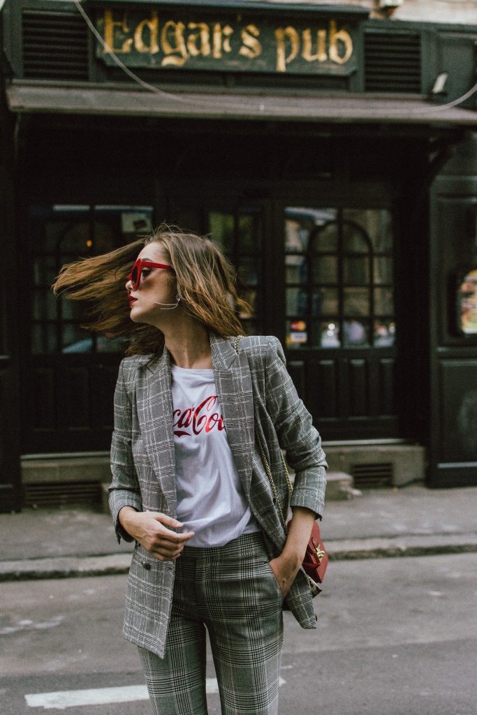 Zara check printed suit, mango check printed blazer,topshop checked flared trousers, checked suit, cropped trousers, gucci white ace heart embroidered sneakers, furla metropolis red bag, coke tee, coca cola t-shirt, andreea birsan, couturezilla, cute fall outfit ideas 2017, check suit, edgy outfit for women, silk scarf, red retro sunglasses, big sunglasses, tomboy chic outfit, how to style a suit, what to wear with a women suit, how to make a suit look casual chic, how to make an outfit look edgy, how to wear a suit with sneakers, sneakers and suits, white shoes, white leather sneakers, statement sneakers, lips printed earrings, statement earrings, red cat eye sunglasses, sunnies, fall outfit ideas for women 2017, transitional outfit ideas, transitional ootd, transitioning into autumn, autumn 2017, moody photoshoot, how to look Parisian chic, European summer street style inspiration for women 2017, pinterest chic outfit ideas for woman, summer outfit ideas, summer ootd inspiration, outfit of the day, ootd, fashion icon, style inspiration, fashionista, fashion inspiration, style inspo, what to wear in summer, how to look French, chic on a budget, zara outfit, mango, topshop, asos, river island, forever 21, urban outfitters, how to mix high end pieces with luxury ones, zara and Gucci,outfit alternatives for summer, tomboy chic, minimal outfit, tumblr girls photos, pictures, happy girl, women, smart casual outfits, the best outfit ideas 2017, what to wear when you don’t feel inspired, summer in Europe, weekend attire, uniform, French women in summer, European outfit ideas 2017, minimal chic outfit, how to stand out, the best outfit ideas for summer, the sunglasses you have seen everywhere on Instagram, glasses, uk fashion blogger, united kingdom, uk fashion blog, fashion and travel blog, Europe, women with style, street style, summer fashion trends 2017, best fashion ideas, styling, fall in europe