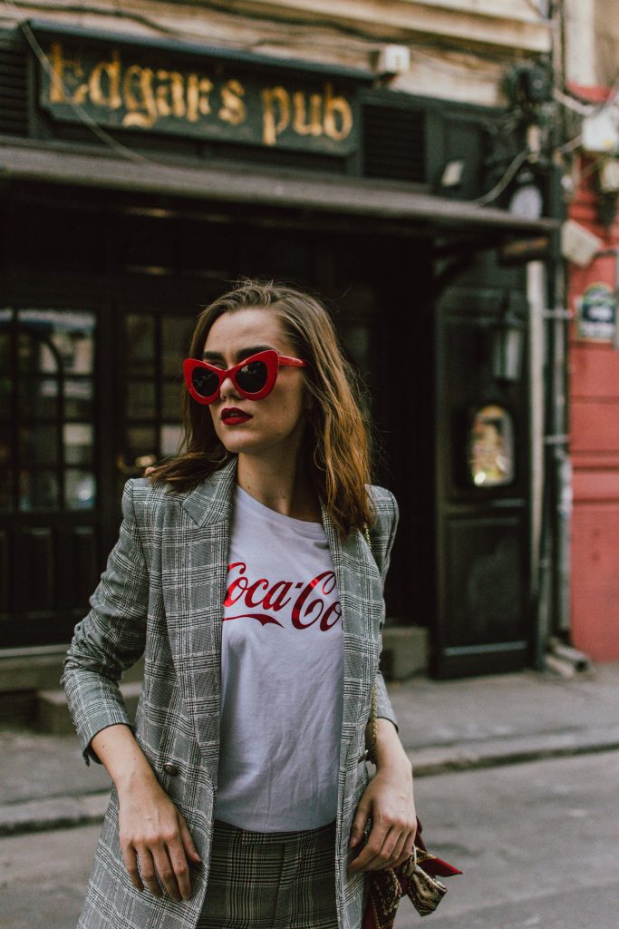 Zara check printed suit, mango check printed blazer,topshop checked flared trousers, checked suit, cropped trousers, gucci white ace heart embroidered sneakers, furla metropolis red bag, coke tee, coca cola t-shirt, andreea birsan, couturezilla, cute fall outfit ideas 2017, check suit, edgy outfit for women, silk scarf, red retro sunglasses, big sunglasses, tomboy chic outfit, how to style a suit, what to wear with a women suit, how to make a suit look casual chic, how to make an outfit look edgy, how to wear a suit with sneakers, sneakers and suits, white shoes, white leather sneakers, statement sneakers, lips printed earrings, statement earrings, red cat eye sunglasses, sunnies, fall outfit ideas for women 2017, transitional outfit ideas, transitional ootd, transitioning into autumn, autumn 2017, moody photoshoot, how to look Parisian chic, European summer street style inspiration for women 2017, pinterest chic outfit ideas for woman, summer outfit ideas, summer ootd inspiration, outfit of the day, ootd, fashion icon, style inspiration, fashionista, fashion inspiration, style inspo, what to wear in summer, how to look French, chic on a budget, zara outfit, mango, topshop, asos, river island, forever 21, urban outfitters, how to mix high end pieces with luxury ones, zara and Gucci,outfit alternatives for summer, tomboy chic, minimal outfit, tumblr girls photos, pictures, happy girl, women, smart casual outfits, the best outfit ideas 2017, what to wear when you don’t feel inspired, summer in Europe, weekend attire, uniform, French women in summer, European outfit ideas 2017, minimal chic outfit, how to stand out, the best outfit ideas for summer, the sunglasses you have seen everywhere on Instagram, glasses, uk fashion blogger, united kingdom, uk fashion blog, fashion and travel blog, Europe, women with style, street style, summer fashion trends 2017, best fashion ideas, styling, fall in europe