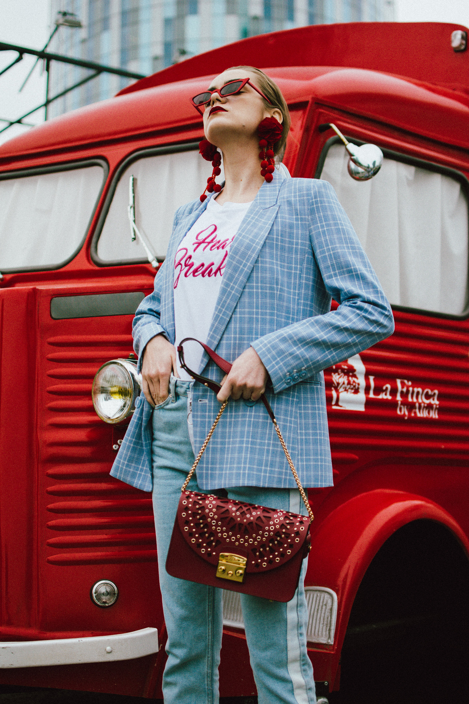 Baby blue checked blazer, statement jeans, furla metropolis red bag, small sunglasses, tee, andreea birsan, couturezilla, cute spring outfit ideas 2018, baby blue blazre, how to wear pastels this spring, jeans with constrastic side panel, redone jeans, reconstructed jeans trend, how to wear reconstructed jeans, red pom pom statement earrings, small cat eye sunglasses in red, retro small sunglasses, small sunnies, matrix sunglasses trend, micro sunglasses trend, red earrings, red and baby blue outfit, how to wear the white shoes trend, white leather high heels, white chuncky heel shoes, white pumps, heart breaker t-shirt, printed tshirt, printed tee, graphic t-shirt, furla red lace cut out metropolis bag, furla leather shoulder bag, furla red metropolis, furla large metropolis bag in red, how to style a furla bag, perfect spring outfit for work and hanging out, red food van, how to look Parisian chic, European summer street style inspiration for women 2017, pinterest chic outfit ideas for woman, summer outfit ideas, summer ootd inspiration, outfit of the day, ootd, fashion icon, style inspiration, fashionista, fashion inspiration, style inspo, what to wear in summer, how to look French, chic on a budget, zara outfit, mango, topshop, asos, river island, forever 21, urban outfitters, how to mix high end pieces with luxury ones, zara and Gucci,outfit alternatives for summer, tomboy chic, minimal outfit, tumblr girls photos, pictures, happy girl, women, smart casual outfits, the best outfit ideas 2017, what to wear when you don’t feel inspired, summer in Europe, weekend attire, uniform, French women in summer, European outfit ideas 2017, minimal chic outfit, how to stand out, the best outfit ideas for summer, the sunglasses you have seen everywhere on Instagram, glasses, uk fashion blogger, united kingdom, uk fashion blog, fashion and travel blog, Europe, women with style, street style, summer fashion trends 2017, best fashion ideas, styling, fall fashion, fall outfit, fall ootd, fall perfect, transitional dressing, best transitional outfit ideas, how to wear statement earrings, dressing for autumn, autumn outfit, winter outfit ideas for work and school 2017