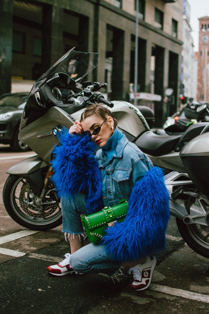 Blue faux fur jacket, levi's cropped light wash jeans, blue cashmere turtleneck sweater, gucci white and red leather sneakers, green saffiano leather prada shoulder bag with studs and stones, small cat eye sunglasses, andreea birsan, couturezilla, cute spring outfit ideas 2018, micro sunglasses trend, retro sunglasses, blue and green outfit, how to pull off double denim, how to wear double denim, denim cropped jacket, denim on denim spring outfit, gold hoop earrings, matrix sunglasses, how to wear the small sunglasses trend, cornbraids hairstyle, green bag, leather shoulder bag, gucci trainers, leather kicks, cookie monster jacket, blue coat, statement jacket, how to look Parisian chic, European summer street style inspiration for women 2017, pinterest chic outfit ideas for woman, summer outfit ideas, summer ootd inspiration, outfit of the day, ootd, fashion icon, style inspiration, fashionista, fashion inspiration, style inspo, what to wear in summer, how to look French, chic on a budget, zara outfit, mango, topshop, asos, river island, forever 21, urban outfitters, how to mix high end pieces with luxury ones, zara and Gucci,outfit alternatives for summer, tomboy chic, minimal outfit, tumblr girls photos, pictures, happy girl, women, smart casual outfits, the best outfit ideas 2017, what to wear when you don’t feel inspired, summer in Europe, weekend attire, uniform, French women in summer, European outfit ideas 2017, minimal chic outfit, how to stand out, the best outfit ideas for summer, the sunglasses you have seen everywhere on Instagram, glasses, uk fashion blogger, united kingdom, uk fashion blog, fashion and travel blog, Europe, women with style, street style, summer fashion trends 2017, best fashion ideas, styling, fall fashion, fall outfit, fall ootd, fall perfect, transitional dressing, best transitional outfit ideas, how to wear statement earrings, dressing for autumn, autumn outfit, winter outfit ideas for work and school 2017