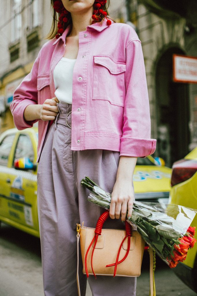 Pastels, pink denim jacket, purple trousers, white shoes, statement earrings, andreea birsan, couturezilla, cute spring outfit ideas 2018, pink and purple spring outfit ideas for 2018, pink cropped cotton jacket, pink trucker jacket, cropped pink denim jacket from na-kd, nakd jacket, mango white camisole top, cami tank top, basic white cami, how to wear a white cami top, how to wear pastels this spring, the pastels fashion trend, head to toe pastels, statement bag, multicolor bag, mini bag, micro tote bag, dusty pink bag, blush pink bag, red statement earrings, earrings with pom poms, xxl earrings, aviator clear lens glasses, the instagram clear lens glasses trend, purple high waisted peg trousers, the best mango trousers, linen and cotton, white leather pumps with block heel, white leather shoes, the white shoes trend, liliac, violet trousers, liliac pants, pastel pants, peg trousers, high waisted trousers with belt detail, how to look Parisian chic, European summer street style inspiration for women 2017, pinterest chic outfit ideas for woman, summer outfit ideas, summer ootd inspiration, outfit of the day, ootd, fashion icon, style inspiration, fashionista, fashion inspiration, style inspo, what to wear in summer, how to look French, chic on a budget, zara outfit, mango, topshop, asos, river island, forever 21, urban outfitters, how to mix high end pieces with luxury ones, zara and Gucci,outfit alternatives for summer, tomboy chic, minimal outfit, tumblr girls photos, pictures, happy girl, women, smart casual outfits, the best outfit ideas 2017, what to wear when you don’t feel inspired, summer in Europe, weekend attire, uniform, French women in summer, European outfit ideas 2017, minimal chic outfit, how to stand out, the best outfit ideas for summer, the sunglasses you have seen everywhere on Instagram, glasses, uk fashion blogger, united kingdom, uk fashion blog, fashion and travel blog, Europe, women with style, street style, summer fashion trends 2017, best fashion ideas, styling, fall fashion, fall outfit, fall ootd, fall perfect, transitional dressing, best transitional outfit ideas, how to wear statement earrings, dressing for autumn, autumn outfit, winter outfit ideas for work and school 2017