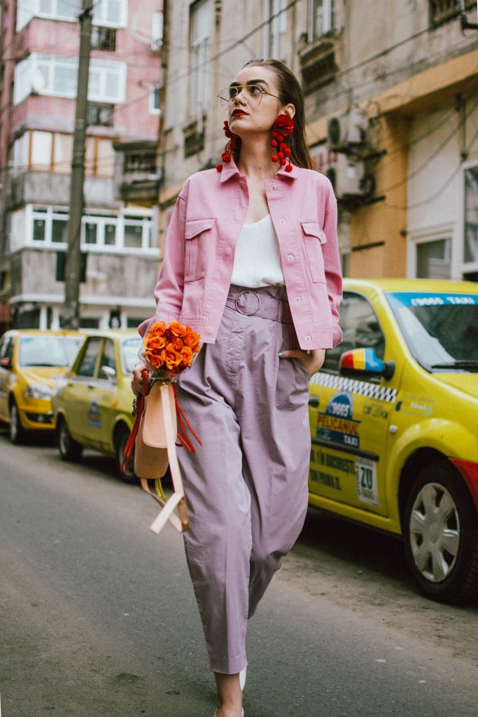 Pastels, pink denim jacket, purple trousers, white shoes, statement earrings, andreea birsan, couturezilla, cute spring outfit ideas 2018, pink and purple spring outfit ideas for 2018, pink cropped cotton jacket, pink trucker jacket, cropped pink denim jacket from na-kd, nakd jacket, mango white camisole top, cami tank top, basic white cami, how to wear a white cami top, how to wear pastels this spring, the pastels fashion trend, head to toe pastels, statement bag, multicolor bag, mini bag, micro tote bag, dusty pink bag, blush pink bag, red statement earrings, earrings with pom poms, xxl earrings, aviator clear lens glasses, the instagram clear lens glasses trend, purple high waisted peg trousers, the best mango trousers, linen and cotton, white leather pumps with block heel, white leather shoes, the white shoes trend, liliac, violet trousers, liliac pants, pastel pants, peg trousers, high waisted trousers with belt detail, how to look Parisian chic, European summer street style inspiration for women 2017, pinterest chic outfit ideas for woman, summer outfit ideas, summer ootd inspiration, outfit of the day, ootd, fashion icon, style inspiration, fashionista, fashion inspiration, style inspo, what to wear in summer, how to look French, chic on a budget, zara outfit, mango, topshop, asos, river island, forever 21, urban outfitters, how to mix high end pieces with luxury ones, zara and Gucci,outfit alternatives for summer, tomboy chic, minimal outfit, tumblr girls photos, pictures, happy girl, women, smart casual outfits, the best outfit ideas 2017, what to wear when you don’t feel inspired, summer in Europe, weekend attire, uniform, French women in summer, European outfit ideas 2017, minimal chic outfit, how to stand out, the best outfit ideas for summer, the sunglasses you have seen everywhere on Instagram, glasses, uk fashion blogger, united kingdom, uk fashion blog, fashion and travel blog, Europe, women with style, street style, summer fashion trends 2017, best fashion ideas, styling, fall fashion, fall outfit, fall ootd, fall perfect, transitional dressing, best transitional outfit ideas, how to wear statement earrings, dressing for autumn, autumn outfit, winter outfit ideas for work and school 2017