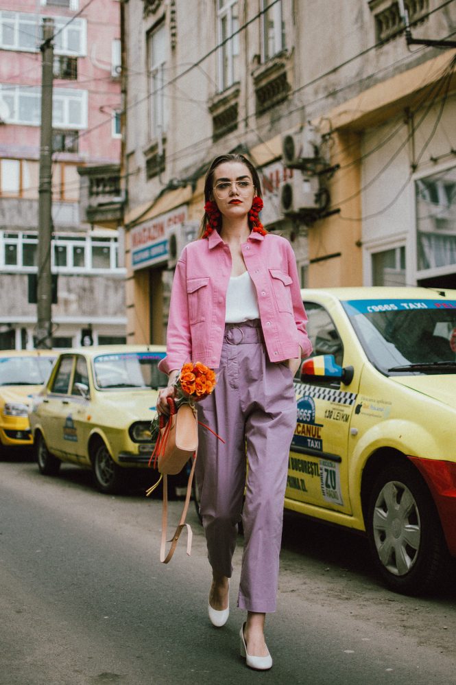 Pastels, pink denim jacket, purple trousers, white shoes, statement earrings, andreea birsan, couturezilla, cute spring outfit ideas 2018, pink and purple spring outfit ideas for 2018, pink cropped cotton jacket, pink trucker jacket, cropped pink denim jacket from na-kd, nakd jacket, mango white camisole top, cami tank top, basic white cami, how to wear a white cami top, how to wear pastels this spring, the pastels fashion trend, head to toe pastels, statement bag, multicolor bag, mini bag, micro tote bag, dusty pink bag, blush pink bag, red statement earrings, earrings with pom poms, xxl earrings, aviator clear lens glasses, the instagram clear lens glasses trend, purple high waisted peg trousers, the best mango trousers, linen and cotton, white leather pumps with block heel, white leather shoes, the white shoes trend, liliac, violet trousers, liliac pants, pastel pants, peg trousers, high waisted trousers with belt detail, how to look Parisian chic, European summer street style inspiration for women 2017, pinterest chic outfit ideas for woman, summer outfit ideas, summer ootd inspiration, outfit of the day, ootd, fashion icon, style inspiration, fashionista, fashion inspiration, style inspo, what to wear in summer, how to look French, chic on a budget, zara outfit, mango, topshop, asos, river island, forever 21, urban outfitters, how to mix high end pieces with luxury ones, zara and Gucci,outfit alternatives for summer, tomboy chic, minimal outfit, tumblr girls photos, pictures, happy girl, women, smart casual outfits, the best outfit ideas 2017, what to wear when you don’t feel inspired, summer in Europe, weekend attire, uniform, French women in summer, European outfit ideas 2017, minimal chic outfit, how to stand out, the best outfit ideas for summer, the sunglasses you have seen everywhere on Instagram, glasses, uk fashion blogger, united kingdom, uk fashion blog, fashion and travel blog, Europe, women with style, street style, summer fashion trends 2017, best fashion ideas, styling, fall fashion, fall outfit, fall ootd, fall perfect, transitional dressing, best transitional outfit ideas, how to wear statement earrings, dressing for autumn, autumn outfit, winter outfit ideas for work and school 2017