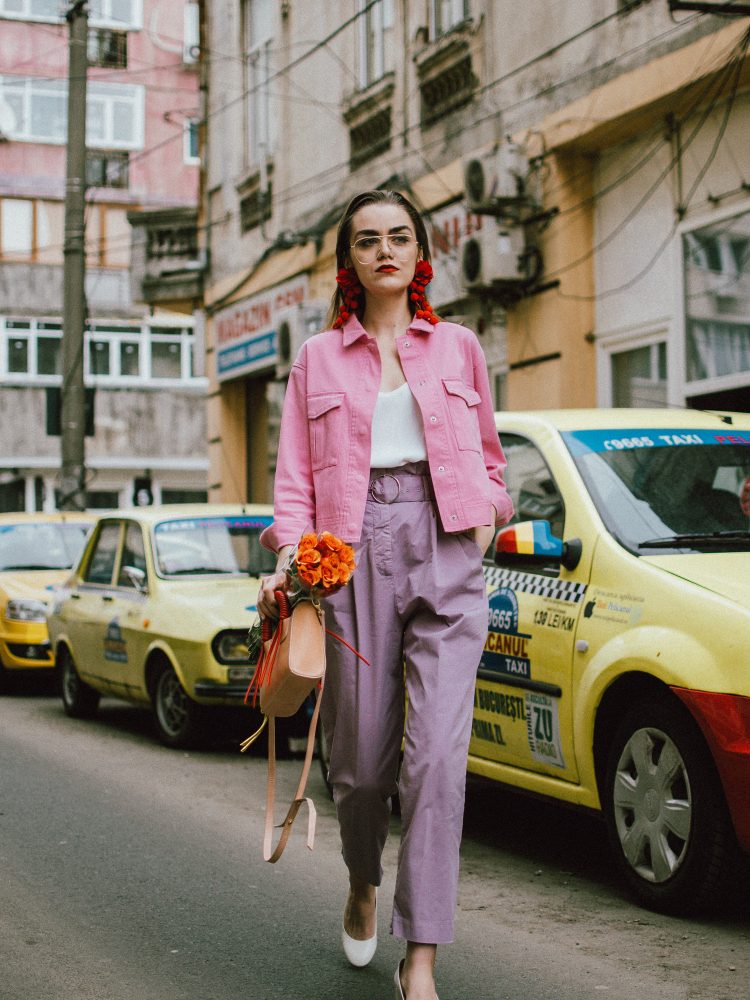 Pastels, pink denim jacket, purple trousers, white shoes, statement earrings, andreea birsan, couturezilla, cute spring outfit ideas 2018, pink and purple spring outfit ideas for 2018, pink cropped cotton jacket, pink trucker jacket, cropped pink denim jacket from na-kd, nakd jacket, mango white camisole top, cami tank top, basic white cami, how to wear a white cami top, how to wear pastels this spring, the pastels fashion trend, head to toe pastels, statement bag, multicolor bag, mini bag, micro tote bag, dusty pink bag, blush pink bag, red statement earrings, earrings with pom poms, xxl earrings, aviator clear lens glasses, the instagram clear lens glasses trend, purple high waisted peg trousers, the best mango trousers, linen and cotton, white leather pumps with block heel, white leather shoes, the white shoes trend, liliac, violet trousers, liliac pants, pastel pants, peg trousers, high waisted trousers with belt detail, how to look Parisian chic, European summer street style inspiration for women 2017, pinterest chic outfit ideas for woman, summer outfit ideas, summer ootd inspiration, outfit of the day, ootd, fashion icon, style inspiration, fashionista, fashion inspiration, style inspo, what to wear in summer, how to look French, chic on a budget, zara outfit, mango, topshop, asos, river island, forever 21, urban outfitters, how to mix high end pieces with luxury ones, zara and Gucci,outfit alternatives for summer, tomboy chic, minimal outfit, tumblr girls photos, pictures, happy girl, women, smart casual outfits, the best outfit ideas 2017, what to wear when you don’t feel inspired, summer in Europe, weekend attire, uniform, French women in summer, European outfit ideas 2017, minimal chic outfit, how to stand out, the best outfit ideas for summer, the sunglasses you have seen everywhere on Instagram, glasses, uk fashion blogger, united kingdom, uk fashion blog, fashion and travel blog, Europe, women with style, street style, summer fashion trends 2017, best fashion ideas, styling, fall fashion, fall outfit, fall ootd, fall perfect, transitional dressing, best transitional outfit ideas, how to wear statement earrings, dressing for autumn, autumn outfit, winter outfit ideas for work and school 2017