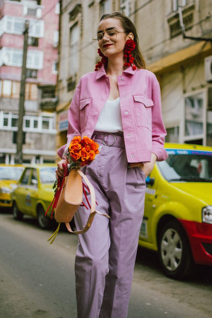 Pastels, pink denim jacket, purple trousers, white shoes, statement earrings, andreea birsan, couturezilla, cute spring outfit ideas 2018, pink and purple spring outfit ideas for 2018, pink cropped cotton jacket, pink trucker jacket, cropped pink denim jacket from na-kd, nakd jacket, mango white camisole top, cami tank top, basic white cami, how to wear a white cami top, how to wear pastels this spring, the pastels fashion trend, head to toe pastels, statement bag, multicolor bag, mini bag, micro tote bag, dusty pink bag, blush pink bag, red statement earrings, earrings with pom poms, xxl earrings, aviator clear lens glasses, the instagram clear lens glasses trend, purple high waisted peg trousers, the best mango trousers, linen and cotton, white leather pumps with block heel, white leather shoes, the white shoes trend, liliac, violet trousers, liliac pants, pastel pants, peg trousers, high waisted trousers with belt detail, how to look Parisian chic, European summer street style inspiration for women 2017, pinterest chic outfit ideas for woman, summer outfit ideas, summer ootd inspiration, outfit of the day, ootd, fashion icon, style inspiration, fashionista, fashion inspiration, style inspo, what to wear in summer, how to look French, chic on a budget, zara outfit, mango, topshop, asos, river island, forever 21, urban outfitters, how to mix high end pieces with luxury ones, zara and Gucci,outfit alternatives for summer, tomboy chic, minimal outfit, tumblr girls photos, pictures, happy girl, women, smart casual outfits, the best outfit ideas 2017, what to wear when you don’t feel inspired, summer in Europe, weekend attire, uniform, French women in summer, European outfit ideas 2017, minimal chic outfit, how to stand out, the best outfit ideas for summer, the sunglasses you have seen everywhere on Instagram, glasses, uk fashion blogger, united kingdom, uk fashion blog, fashion and travel blog, Europe, women with style, street style, summer fashion trends 2017, best fashion ideas, styling, fall fashion, fall outfit, fall ootd, fall perfect, transitional dressing, best transitional outfit ideas, how to wear statement earrings, dressing for autumn, autumn outfit, winter outfit ideas for work and school 2017