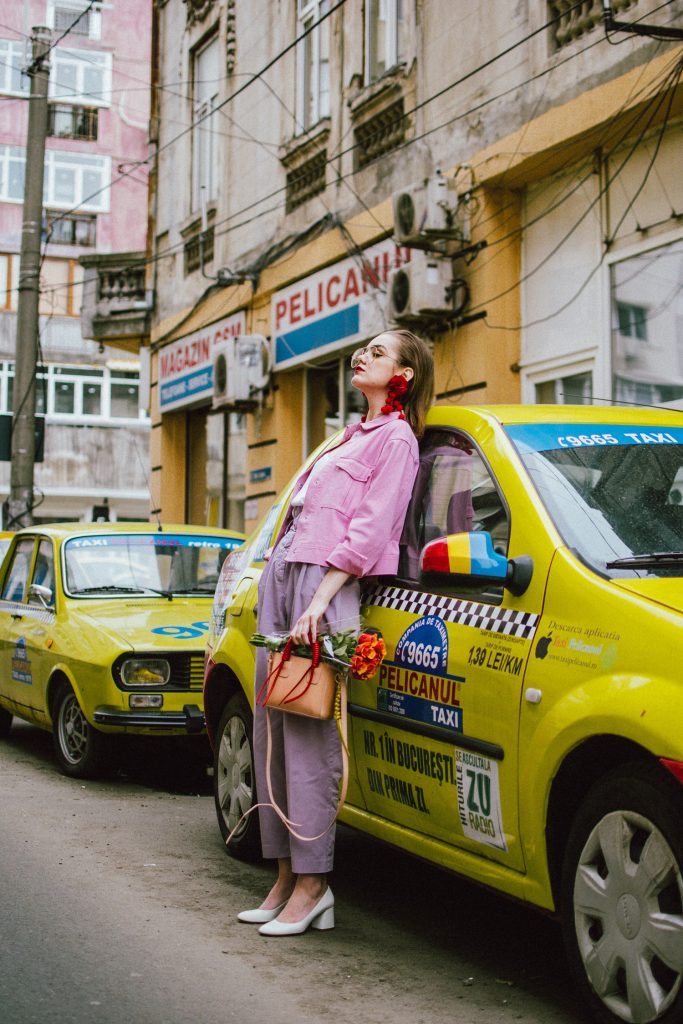 Pastels, pink denim jacket, purple trousers, white shoes, statement earrings, andreea birsan, couturezilla, cute spring outfit ideas 2018, pink and purple spring outfit ideas for 2018, pink cropped cotton jacket, pink trucker jacket, cropped pink denim jacket from na-kd, nakd jacket, mango white camisole top, cami tank top, basic white cami, how to wear a white cami top, how to wear pastels this spring, the pastels fashion trend, head to toe pastels, statement bag, multicolor bag, mini bag, micro tote bag, dusty pink bag, blush pink bag, red statement earrings, earrings with pom poms, xxl earrings, aviator clear lens glasses, the instagram clear lens glasses trend, purple high waisted peg trousers, the best mango trousers, linen and cotton, white leather pumps with block heel, white leather shoes, the white shoes trend, liliac, violet trousers, liliac pants, pastel pants, peg trousers, high waisted trousers with belt detail, how to look Parisian chic, European summer street style inspiration for women 2017, pinterest chic outfit ideas for woman, summer outfit ideas, summer ootd inspiration, outfit of the day, ootd, fashion icon, style inspiration, fashionista, fashion inspiration, style inspo, what to wear in summer, how to look French, chic on a budget, zara outfit, mango, topshop, asos, river island, forever 21, urban outfitters, how to mix high end pieces with luxury ones, zara and Gucci,outfit alternatives for summer, tomboy chic, minimal outfit, tumblr girls photos, pictures, happy girl, women, smart casual outfits, the best outfit ideas 2017, what to wear when you don’t feel inspired, summer in Europe, weekend attire, uniform, French women in summer, European outfit ideas 2017, minimal chic outfit, how to stand out, the best outfit ideas for summer, the sunglasses you have seen everywhere on Instagram, glasses, uk fashion blogger, united kingdom, uk fashion blog, fashion and travel blog, Europe, women with style, street style, summer fashion trends 2017, best fashion ideas, styling, fall fashion, fall outfit, fall ootd, fall perfect, transitional dressing, best transitional outfit ideas, how to wear statement earrings, dressing for autumn, autumn outfit, winter outfit ideas for work and school 2017