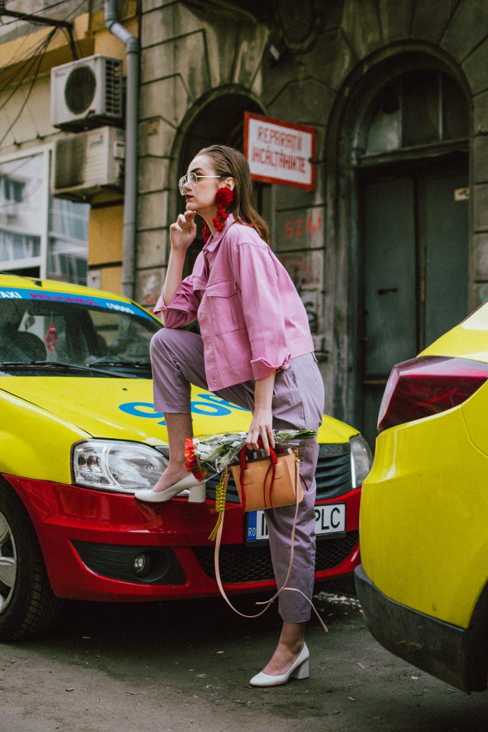 Pastels, pink denim jacket, purple trousers, white shoes, statement earrings, andreea birsan, couturezilla, cute spring outfit ideas 2018, pink and purple spring outfit ideas for 2018, pink cropped cotton jacket, pink trucker jacket, cropped pink denim jacket from na-kd, nakd jacket, mango white camisole top, cami tank top, basic white cami, how to wear a white cami top, how to wear pastels this spring, the pastels fashion trend, head to toe pastels, statement bag, multicolor bag, mini bag, micro tote bag, dusty pink bag, blush pink bag, red statement earrings, earrings with pom poms, xxl earrings, aviator clear lens glasses, the instagram clear lens glasses trend, purple high waisted peg trousers, the best mango trousers, linen and cotton, white leather pumps with block heel, white leather shoes, the white shoes trend, liliac, violet trousers, liliac pants, pastel pants, peg trousers, high waisted trousers with belt detail, how to look Parisian chic, European summer street style inspiration for women 2017, pinterest chic outfit ideas for woman, summer outfit ideas, summer ootd inspiration, outfit of the day, ootd, fashion icon, style inspiration, fashionista, fashion inspiration, style inspo, what to wear in summer, how to look French, chic on a budget, zara outfit, mango, topshop, asos, river island, forever 21, urban outfitters, how to mix high end pieces with luxury ones, zara and Gucci,outfit alternatives for summer, tomboy chic, minimal outfit, tumblr girls photos, pictures, happy girl, women, smart casual outfits, the best outfit ideas 2017, what to wear when you don’t feel inspired, summer in Europe, weekend attire, uniform, French women in summer, European outfit ideas 2017, minimal chic outfit, how to stand out, the best outfit ideas for summer, the sunglasses you have seen everywhere on Instagram, glasses, uk fashion blogger, united kingdom, uk fashion blog, fashion and travel blog, Europe, women with style, street style, summer fashion trends 2017, best fashion ideas, styling, fall fashion, fall outfit, fall ootd, fall perfect, transitional dressing, best transitional outfit ideas, how to wear statement earrings, dressing for autumn, autumn outfit, winter outfit ideas for work and school 2017