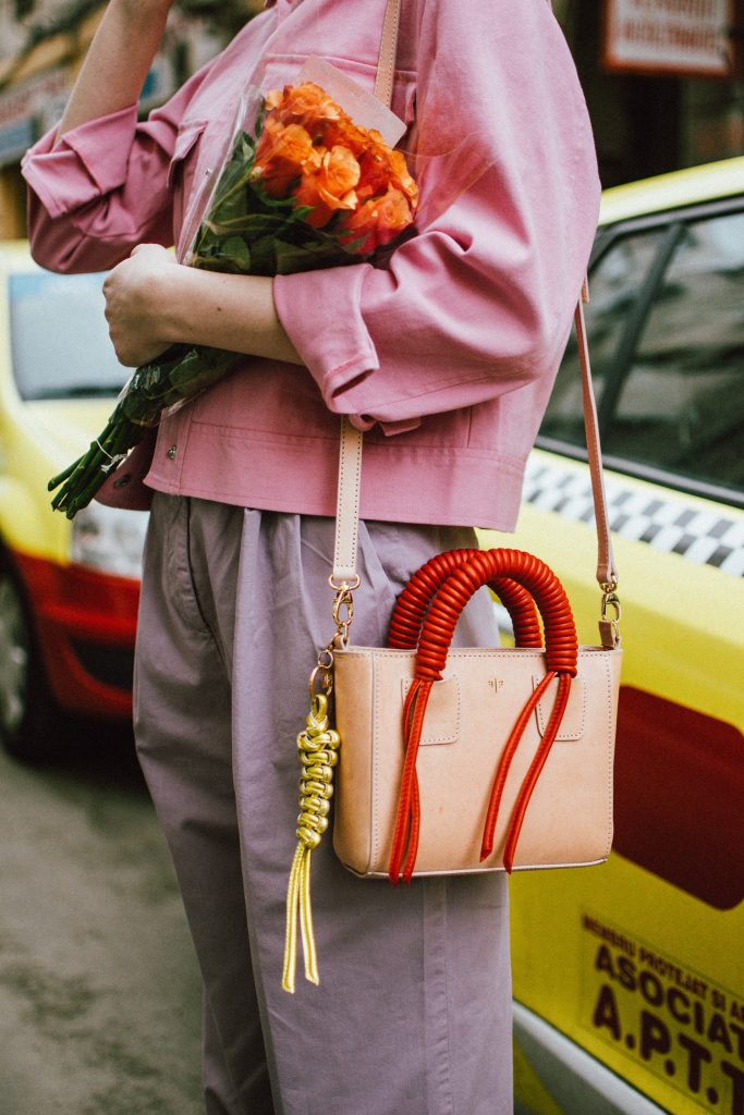 Pastels, pink denim jacket, purple trousers, white shoes, statement earrings, andreea birsan, couturezilla, cute spring outfit ideas 2018, pink and purple spring outfit ideas for 2018, pink cropped cotton jacket, pink trucker jacket, cropped pink denim jacket from na-kd, nakd jacket, mango white camisole top, cami tank top, basic white cami, how to wear a white cami top, how to wear pastels this spring, the pastels fashion trend, head to toe pastels, statement bag, multicolor bag, mini bag, micro tote bag, dusty pink bag, blush pink bag, red statement earrings, earrings with pom poms, xxl earrings, aviator clear lens glasses, the instagram clear lens glasses trend, purple high waisted peg trousers, the best mango trousers, linen and cotton, white leather pumps with block heel, white leather shoes, the white shoes trend, liliac, violet trousers, liliac pants, pastel pants, peg trousers, high waisted trousers with belt detail, how to look Parisian chic, European summer street style inspiration for women 2017, pinterest chic outfit ideas for woman, summer outfit ideas, summer ootd inspiration, outfit of the day, ootd, fashion icon, style inspiration, fashionista, fashion inspiration, style inspo, what to wear in summer, how to look French, chic on a budget, zara outfit, mango, topshop, asos, river island, forever 21, urban outfitters, how to mix high end pieces with luxury ones, zara and Gucci,outfit alternatives for summer, tomboy chic, minimal outfit, tumblr girls photos, pictures, happy girl, women, smart casual outfits, the best outfit ideas 2017, what to wear when you don’t feel inspired, summer in Europe, weekend attire, uniform, French women in summer, European outfit ideas 2017, minimal chic outfit, how to stand out, the best outfit ideas for summer, the sunglasses you have seen everywhere on Instagram, glasses, uk fashion blogger, united kingdom, uk fashion blog, fashion and travel blog, Europe, women with style, street style, summer fashion trends 2017, best fashion ideas, styling, fall fashion, fall outfit, fall ootd, fall perfect, transitional dressing, best transitional outfit ideas, how to wear statement earrings, dressing for autumn, autumn outfit, winter outfit ideas for work and school 2017