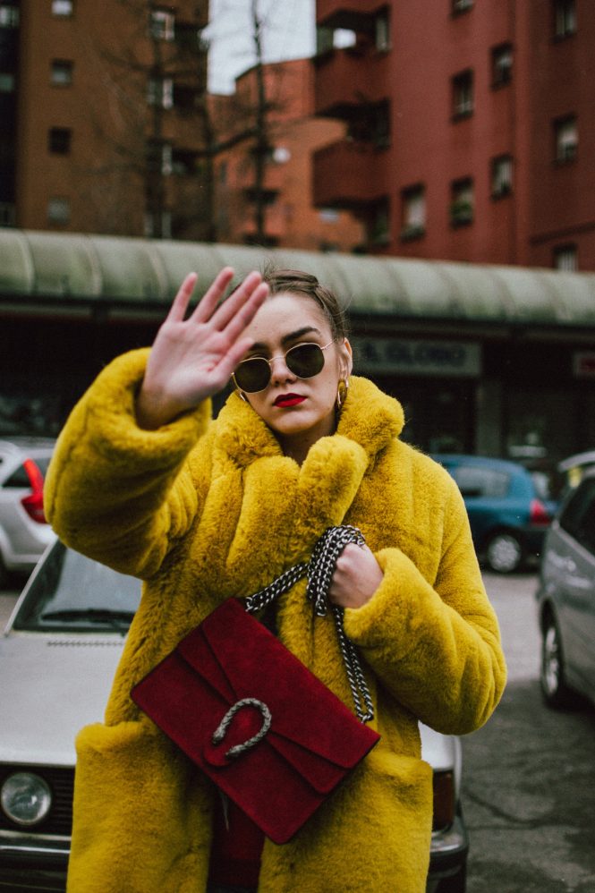 Boohoo yellow faux fur coat, double denim levi's jeans, gucci sneakers, gucci bag, milan, cute winter outfit 2018, andreea birsan, couturezilla, cropped raw hem levi’s jeans, raw hem star printed cropped denim jacket, red cashmere sweater, t-shirt, ray ban hexagonal sunglasses, gucci red suede dionysus bag, gucci white and red sneakers, how to wear sneakers in winter, how to wear double denim like a pro, colorful coat, teddy bear coat in yellow, corn braids, heart shaped earrings, how to dress in winter, how to layer like a fashion blogger, yellow red and blue outfit, best gucci sneakers, how to look Parisian chic, European summer street style inspiration for women 2017, pinterest chic outfit ideas for woman, summer outfit ideas, summer ootd inspiration, outfit of the day, ootd, fashion icon, style inspiration, fashionista, fashion inspiration, style inspo, what to wear in summer, how to look French, chic on a budget, zara outfit, mango, topshop, asos, river island, forever 21, urban outfitters, how to mix high end pieces with luxury ones, zara and Gucci,outfit alternatives for summer, tomboy chic, minimal outfit, tumblr girls photos, pictures, happy girl, women, smart casual outfits, the best outfit ideas 2017, what to wear when you don’t feel inspired, summer in Europe, weekend attire, uniform, French women in summer, European outfit ideas 2017, minimal chic outfit, how to stand out, the best outfit ideas for summer, the sunglasses you have seen everywhere on Instagram, glasses, uk fashion blogger, united kingdom, uk fashion blog, fashion and travel blog, Europe, women with style, street style, summer fashion trends 2017, best fashion ideas, styling, fall fashion, fall outfit, fall ootd, fall perfect, transitional dressing, best transitional outfit ideas, how to wear statement earrings, dressing for autumn, autumn outfit, winter outfit ideas for work and school 2017