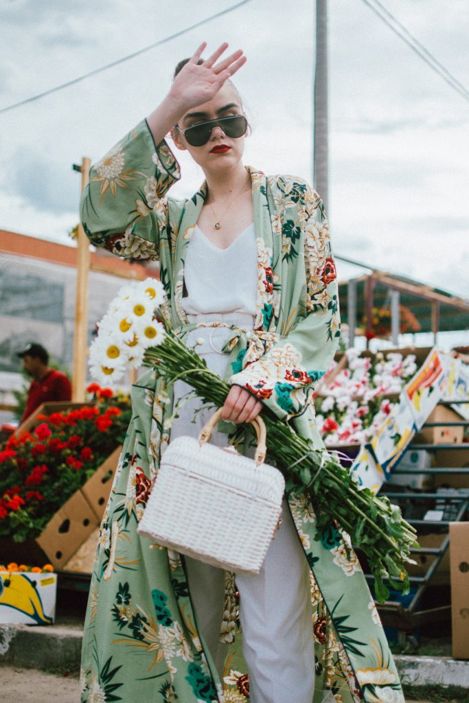 Boohoo green maxi floral kimono, floral print kimono, mango white peg trousers with belt, zara white cami top, musette tropical print leather mules, white handmade basket bag, andreea birsan, couturezilla, cute spring and summer outfit ideas 2018, white straw bag, raffia bag, wicker bag, limited edition mango bag, the cutest bags from mango, bamboo bag, tropical print and floral print, how to mix different prints in one outfit, the not so boring all white outfit for spring and summer, how to wear wide leg trousers, the peg trousers trend, pleated pants, white pants, how to wear white trousers, simple white cami top, wardrobe staples, wardrobe classics, big sunglasses, oversized sunglasses, oversize sunglasses, smoked lens sunglasses, moon necklace, white pants and top, kimono, maxi kimono, how to wear a kimono, the best way to wear a kimono in spring and summer, the popular zara sold out floral print kimono, the zara kimono, how to look Parisian chic, European summer street style inspiration for women 2017, pinterest chic outfit ideas for woman, summer outfit ideas, summer ootd inspiration, outfit of the day, ootd, fashion icon, style inspiration, fashionista, fashion inspiration, style inspo, what to wear in summer, how to look French, chic on a budget, zara outfit, mango, topshop, asos, river island, forever 21, urban outfitters, how to mix high end pieces with luxury ones, zara and Gucci,outfit alternatives for summer, tomboy chic, minimal outfit, tumblr girls photos, pictures, happy girl, women, smart casual outfits, the best outfit ideas 2017, what to wear when you don’t feel inspired, summer in Europe, weekend attire, uniform, French women in summer, European outfit ideas 2017, minimal chic outfit, how to stand out, the best outfit ideas for summer, the sunglasses you have seen everywhere on Instagram, glasses, uk fashion blogger, united kingdom, uk fashion blog, fashion and travel blog, Europe, women with style, street style, summer fashion trends 2017, best fashion ideas, styling, fall fashion, fall outfit, fall ootd, fall perfect, transitional dressing, best transitional outfit ideas, how to wear statement earrings, dressing for autumn, autumn outfit, winter outfit ideas for work and school 2017