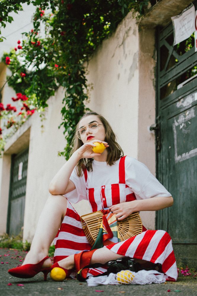 Midi striped dress, white t-shirt, red slingback shoes, cult gaia bag, andreea birsan, couturezilla, cute summer outfit ideas 2018, boohoo red and white striped midi dress, stripe, stripes dress, the perfect summer bag, cult gaia bag, cult gaia lookalike bag, the popular cult gaia bag you have seen all over instagram, zara clear lens aviator glasses, h&m suede kitten heel sling back shoes, red slingback shoes, slingbacks, cotton white t-shirt, white tee, basic white tee, how to layer a dress, dress over tshirt, summer layers, how to layer in summer, roses, heart shaped earrings, bamboo bag, basket bag, raffia bag, handmade bag, woven bag, wicker bag, the perfect summer dress, what to wear when it’s hot, how to look Parisian chic, European summer street style inspiration for women 2017, pinterest chic outfit ideas for woman, summer outfit ideas, summer ootd inspiration, outfit of the day, ootd, fashion icon, style inspiration, fashionista, fashion inspiration, style inspo, what to wear in summer, how to look French, chic on a budget, zara outfit, mango, topshop, asos, river island, forever 21, urban outfitters, how to mix high end pieces with luxury ones, zara and Gucci,outfit alternatives for summer, tomboy chic, minimal outfit, tumblr girls photos, pictures, happy girl, women, smart casual outfits, the best outfit ideas 2017, what to wear when you don’t feel inspired, summer in Europe, weekend attire, uniform, French women in summer, European outfit ideas 2017, minimal chic outfit, how to stand out, the best outfit ideas for summer, the sunglasses you have seen everywhere on Instagram, glasses, uk fashion blogger, united kingdom, uk fashion blog, fashion and travel blog, Europe, women with style, street style, summer fashion trends 2017, best fashion ideas, styling, fall fashion, fall outfit, fall ootd, fall perfect, transitional dressing, best transitional outfit ideas, how to wear statement earrings, dressing for autumn, autumn outfit, winter outfit ideas for work and school 2017