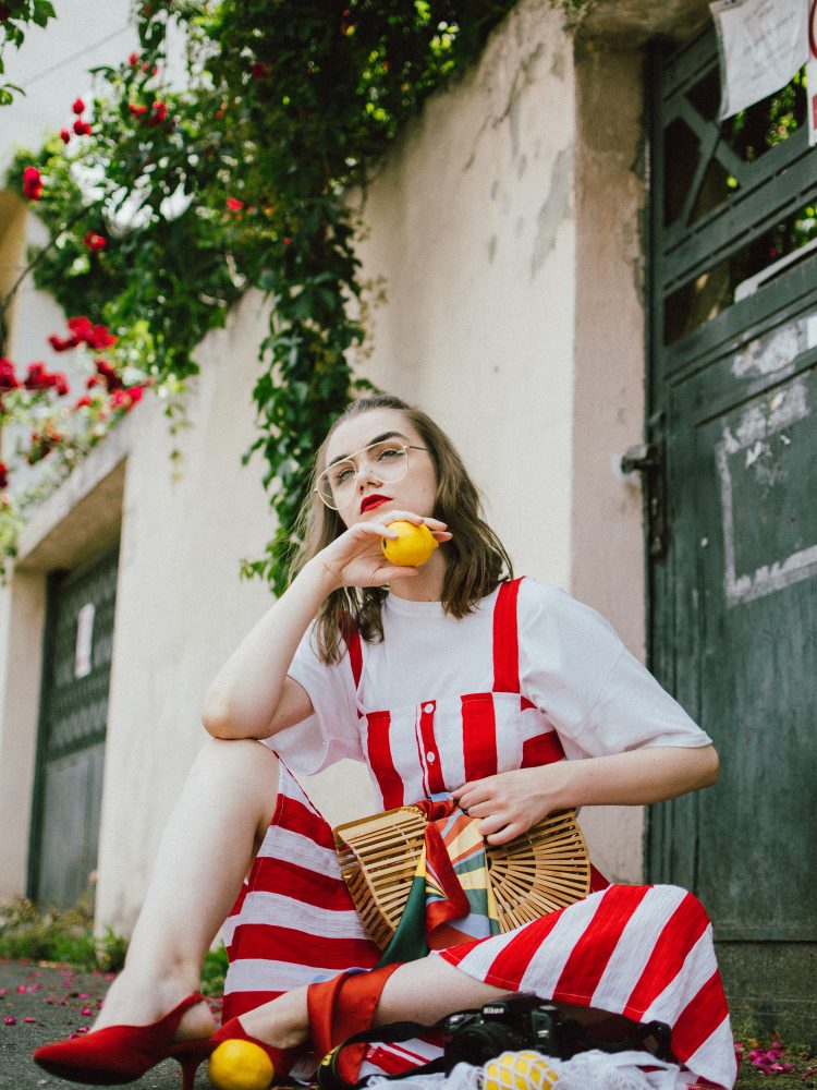 Midi striped dress, white t-shirt, red slingback shoes, cult gaia bag, andreea birsan, couturezilla, cute summer outfit ideas 2018, boohoo red and white striped midi dress, stripe, stripes dress, the perfect summer bag, cult gaia bag, cult gaia lookalike bag, the popular cult gaia bag you have seen all over instagram, zara clear lens aviator glasses, h&m suede kitten heel sling back shoes, red slingback shoes, slingbacks, cotton white t-shirt, white tee, basic white tee, how to layer a dress, dress over tshirt, summer layers, how to layer in summer, roses, heart shaped earrings, bamboo bag, basket bag, raffia bag, handmade bag, woven bag, wicker bag, the perfect summer dress, what to wear when it’s hot, how to look Parisian chic, European summer street style inspiration for women 2017, pinterest chic outfit ideas for woman, summer outfit ideas, summer ootd inspiration, outfit of the day, ootd, fashion icon, style inspiration, fashionista, fashion inspiration, style inspo, what to wear in summer, how to look French, chic on a budget, zara outfit, mango, topshop, asos, river island, forever 21, urban outfitters, how to mix high end pieces with luxury ones, zara and Gucci,outfit alternatives for summer, tomboy chic, minimal outfit, tumblr girls photos, pictures, happy girl, women, smart casual outfits, the best outfit ideas 2017, what to wear when you don’t feel inspired, summer in Europe, weekend attire, uniform, French women in summer, European outfit ideas 2017, minimal chic outfit, how to stand out, the best outfit ideas for summer, the sunglasses you have seen everywhere on Instagram, glasses, uk fashion blogger, united kingdom, uk fashion blog, fashion and travel blog, Europe, women with style, street style, summer fashion trends 2017, best fashion ideas, styling, fall fashion, fall outfit, fall ootd, fall perfect, transitional dressing, best transitional outfit ideas, how to wear statement earrings, dressing for autumn, autumn outfit, winter outfit ideas for work and school 2017